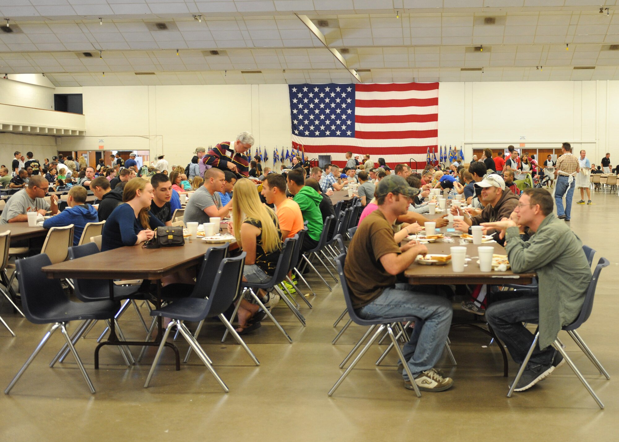 Military members and their families gather at the Abilene Civic Center during the World’s Largest Barbeque April 20, 2013, in Abilene, Texas. Each year, the Abilene Chamber of Commerce Military Affairs Committee host’s the barbeque to show appreciation to all active-duty, reservists, national guard, Department of Defense civilian personnel and their families. This year marked 48 years of the ongoing tradition. (U.S. Air Force photo by Senior Airman Cierra Presentado/Released)