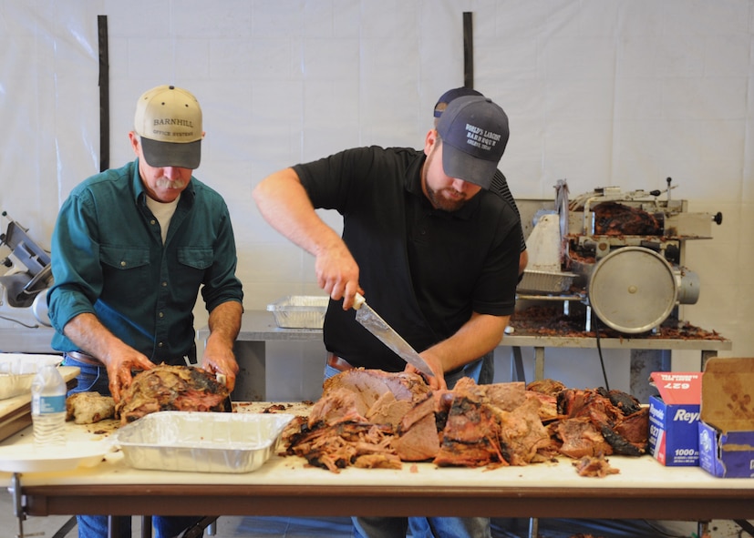 Kevin Wills, left, and Jacob Weckwerth prepare brisket during the World’s Largest Barbeque April 20, 2013, at the Abilene Civic Center in Abilene, Texas. Members of the Abilene Chamber of Commerce Military Affairs Committee hosted the barbeque to express Abilene’s appreciation for all active-duty, reservists, national guard, Department of Defense civilian personnel and their families for being a part of the Abilene community and for their military service.  (U.S. Air Force photo by Senior Airman Cierra Presentado/Released) 