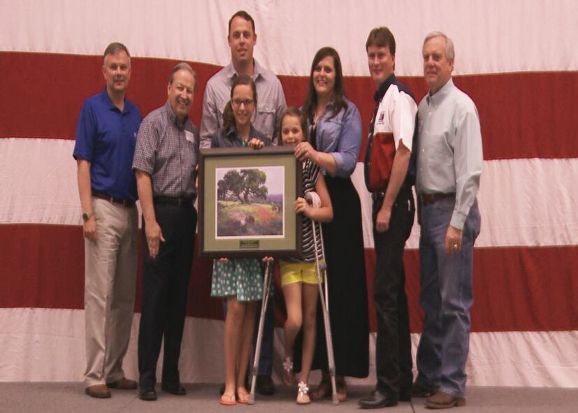 Lt. Col. Brian Witkowski, 28th Bomb Squadron, and his family were recognized as the 7th Bomb Wing’s family of the year at the World’s Largest Barbeque April 20, 2013, at the Abilene Civic Center in Abilene, Texas. The Witkowski family received this award due to their hard work and dedication serving both the military and local community through volunteer service and community involvement. (U.S. Air Force photo by Senior Airman Cierra Presentado/Released)