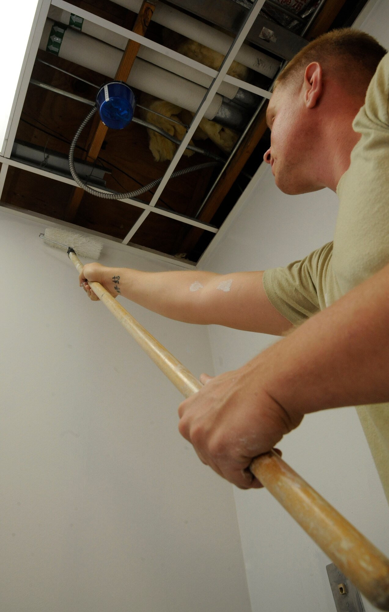 Staff Sgt. Shane Stevenson, 2nd Civil Engineer Squadron Structures shop, paints a wall during construction of a concession stand at the pool at the Barksdale Club on Barksdale Air Force Base, La., April 22, 2013. The pool is currently undergoing renovations which include, replacing the barber shop with a concession stand, renovating bathrooms and the addition of large waterslides. (U.S. Air Force photo/Airman 1st Class Andrew Moua)
