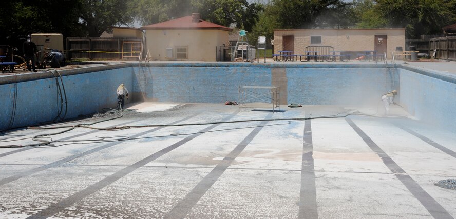 Contractors sandblast the pool at the Barksdale Club on Barksdale Air Force Base, La., April 22, 2013. The pool is currently undergoing renovations which include replacing the barber shop with a concession stand, renovating bathrooms and the addition of large waterslides. (U.S. Air Force photo/Airman 1st Class Andrew Moua)