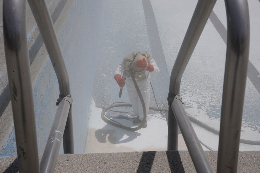 A contractor sandblasts the pool at the Barksdale Club on Barksdale Air Force Base, La., April 22, 2013. The pool is currently undergoing renovations which include replacing the barber shop with a concession stand, renovating bathrooms and the addition of large waterslides. (U.S. Air Force photo/Airman 1st Class Andrew Moua)