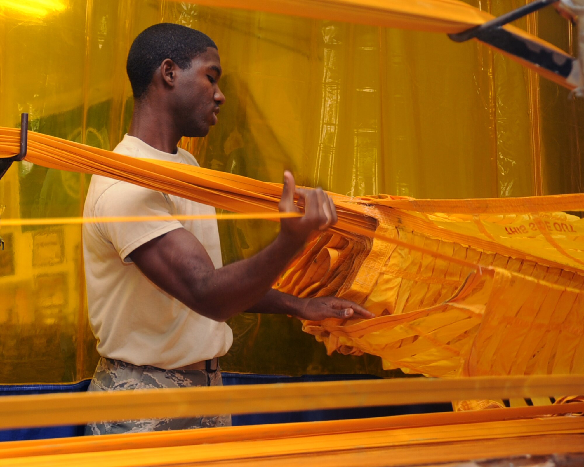 Airman 1st Class Benjamin Green, 2nd Operations Support Squadron Aircrew Flight Equipment, separates lines on a drag parachute on Barksdale Air Force Base, La., April 22, 2013. The 48 lines must be separated in order to properly pack a drag chute. (U.S. Air Force photo/Senior Airman Sean Martin)