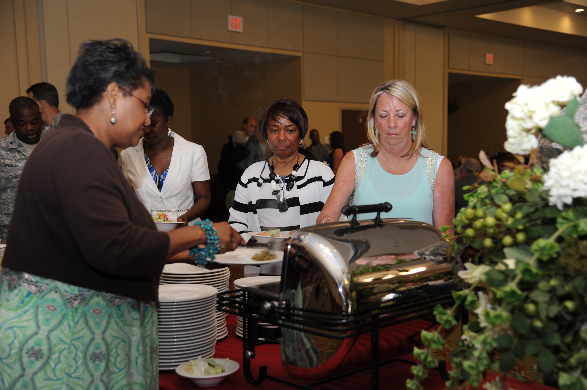 Gloria Johnson, Special Olympics Mississippi board of directors member, and Dorothy Shaw and Robin Poppenhouse, SOMS committee for Ingals shipbuilding members, take food from the buffet line at the SOMS kickoff luncheon April 18, 2013, at the Bay Breeze Event Center, Keesler Air Force Base, Miss.  The purpose of the luncheon was to energize Keesler volunteers and base leadership for the upcoming event that will be hosted by Keesler May 10 and 11.  (U.S. Air Force photo by Kemberly Groue)