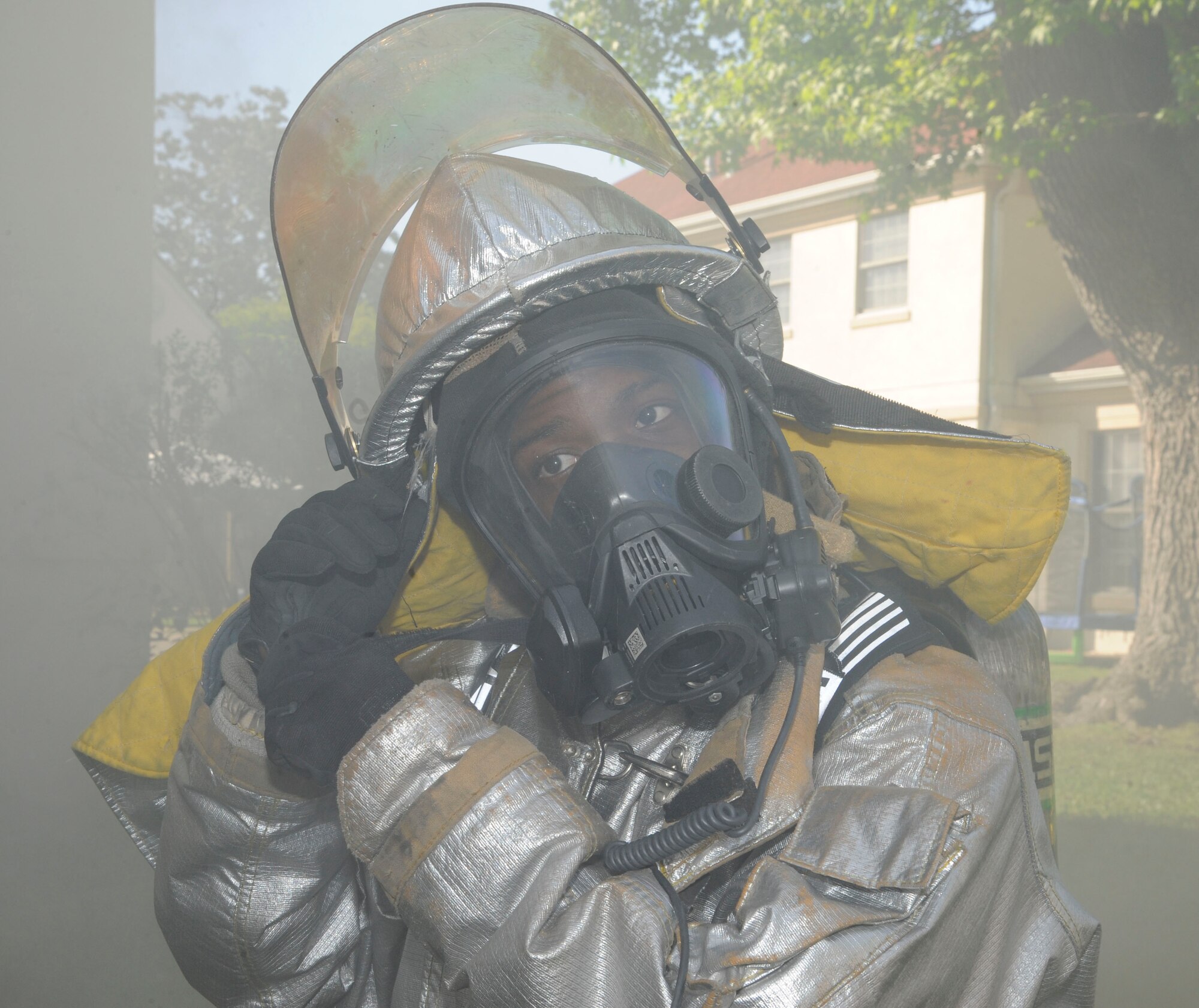 Senior Airman Trey Moorer, 2nd Civil Engineer Squadron firefighter, dons his personal protective equipment before participating in an exercise on Barksdale Air Force Base, La., April 20, 2013. The exercise put firefighters in a simulated house fire where they established water lines, practiced methods of entry and extinguished simulated fires. (U.S. Air Force photo/Airman 1st Class Andrew Moua)