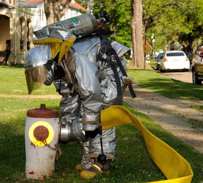Senior Airman Trey Moorer, 2nd Civil Engineer Squadron firefighter, establishes a water line during a training exercise on Barksdale Air Force Base, La., April 20, 2013. The exercise put firefighters in a simulated house fire where they established water lines, practiced methods of entry and extinguished simulated fires. (U.S. Air Force photo/Airman 1st Class Andrew Moua)