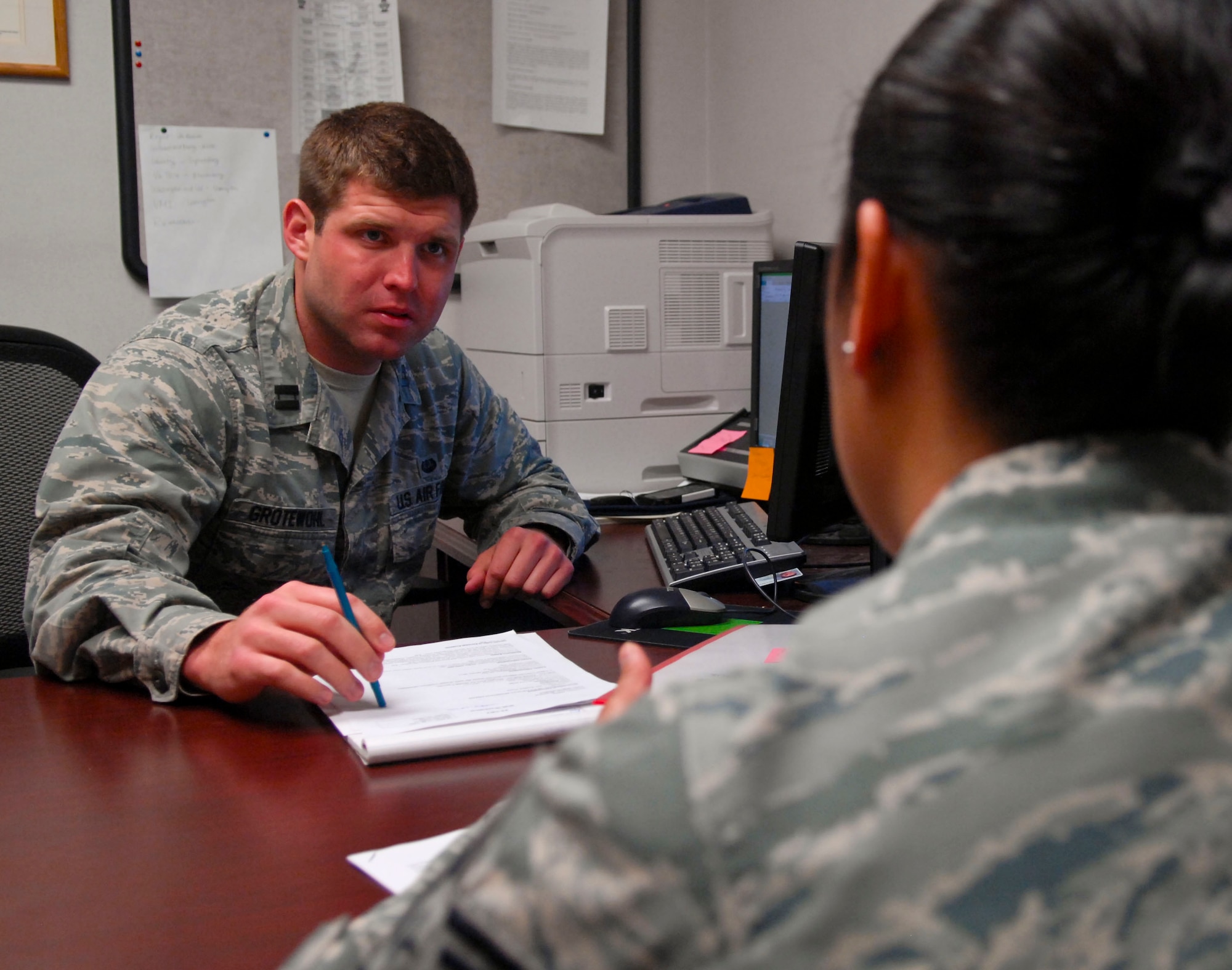 U.S. Air Force Capt. C.J. Grotewohl, 633rd Air Base Wing legal assistance chief, helps an Airman update her will, April 18, 2013, at Langley Air Force Base, Va. The entire legal team processes approximately 20 to 25 wills each week. (U.S. Air Force photo by Airman 1st Class Austin Harvill/Released)