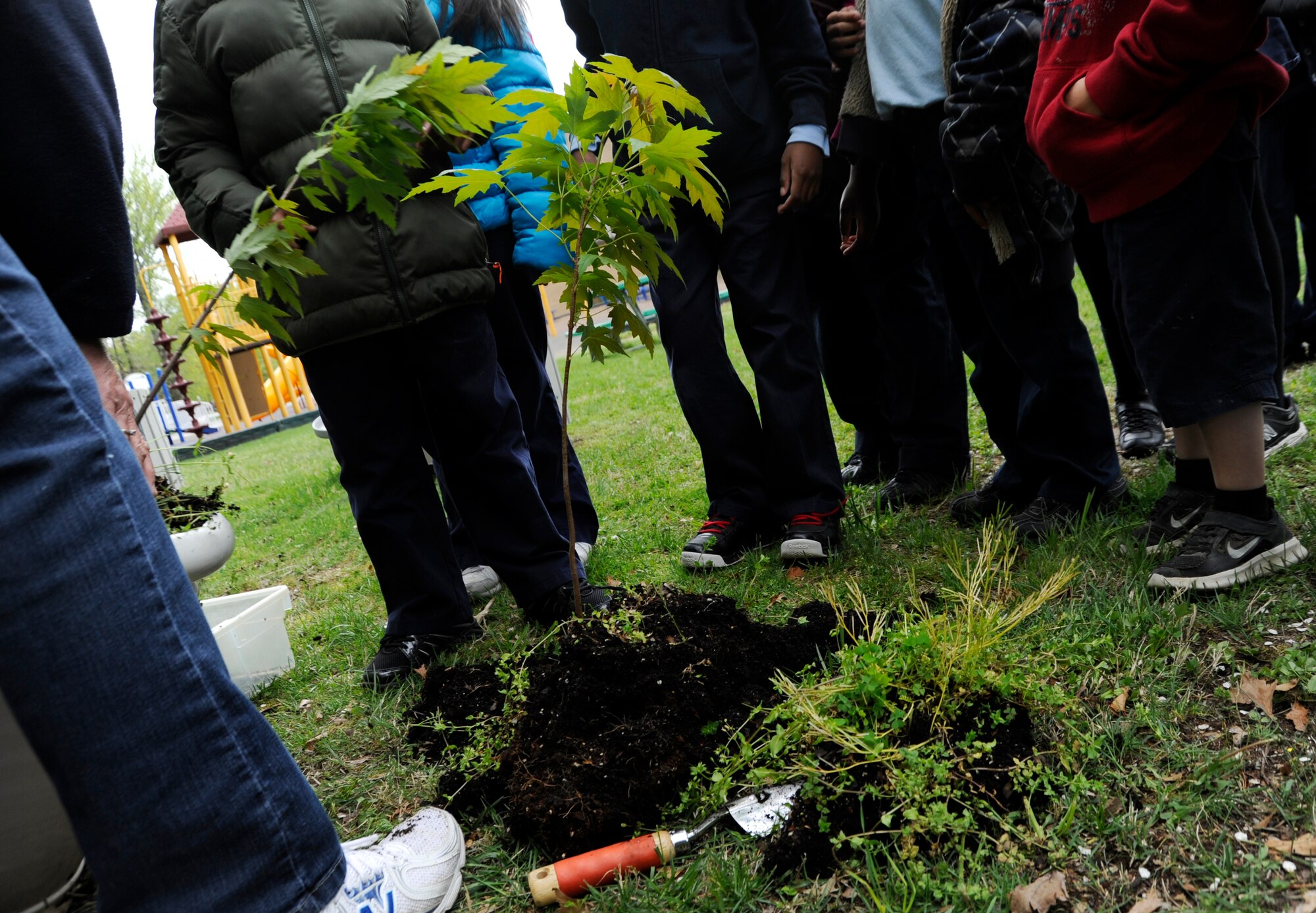 Children from Joint Base Andrews Youth Center learn how to replant a potted tree April 22, 2013 at Joint Base Andrews, Md. Trees provide shade and shelter, reducing yearly heating and cooling costs by 2.1 billion dollars according to the International Society of Arboriculture. (U.S. Air Force photo/Airman 1st Class Nesha Humes)