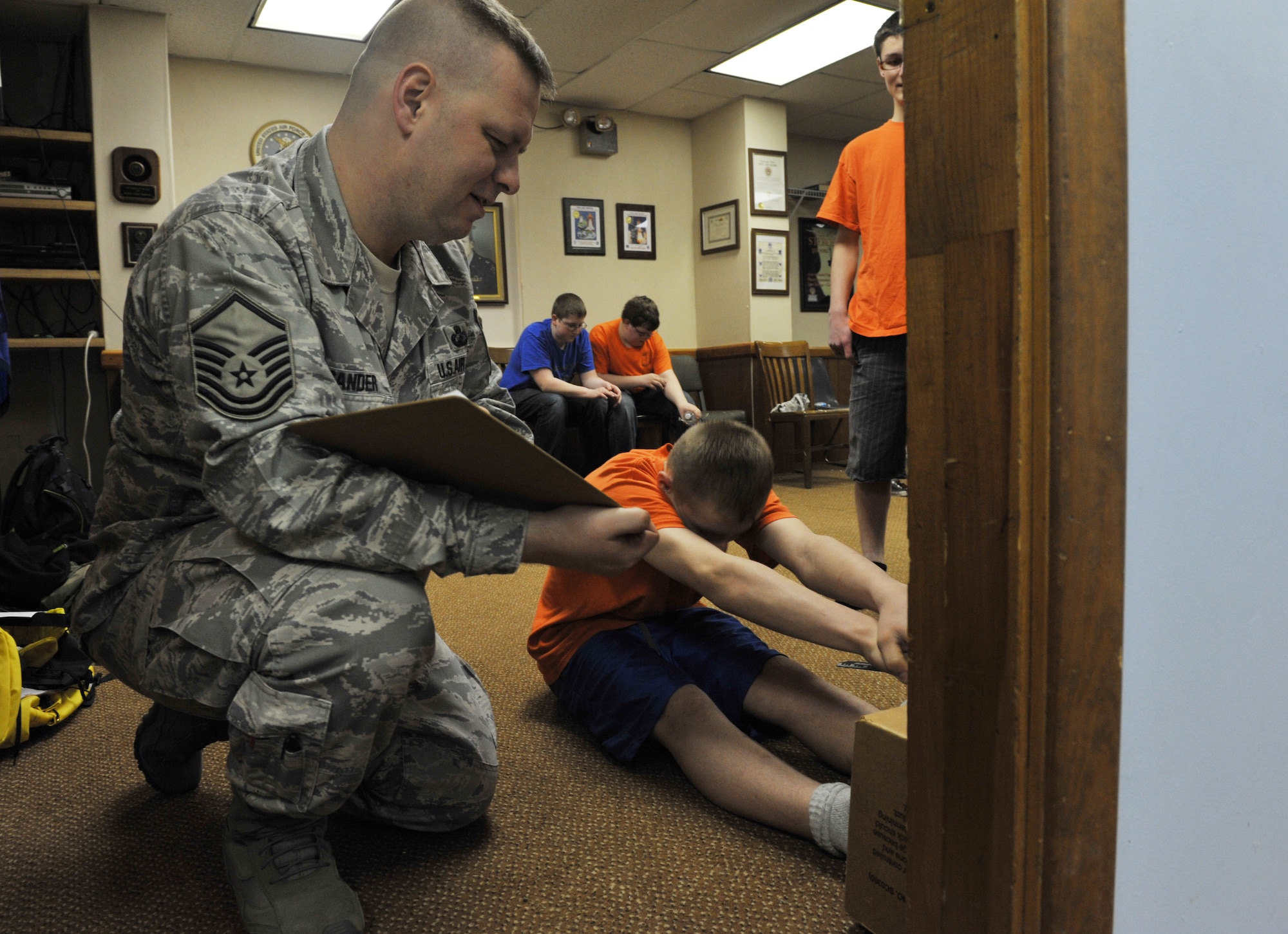 Master Sgt. William Sander, 509th Comptroller Squadron financial services superintendent, measures Camren’s, 15, a Civil Air Patrol cadet, sit-and-reach physical assessment, March 28, 2013, in Sedalia, Mo. The cadet physical fitness training is aligned with the President’s Challenge, a fitness program sponsored by the President’s Council on Physical Fitness and Sports. (U.S. Air Force photo by Heidi Hunt/Released)