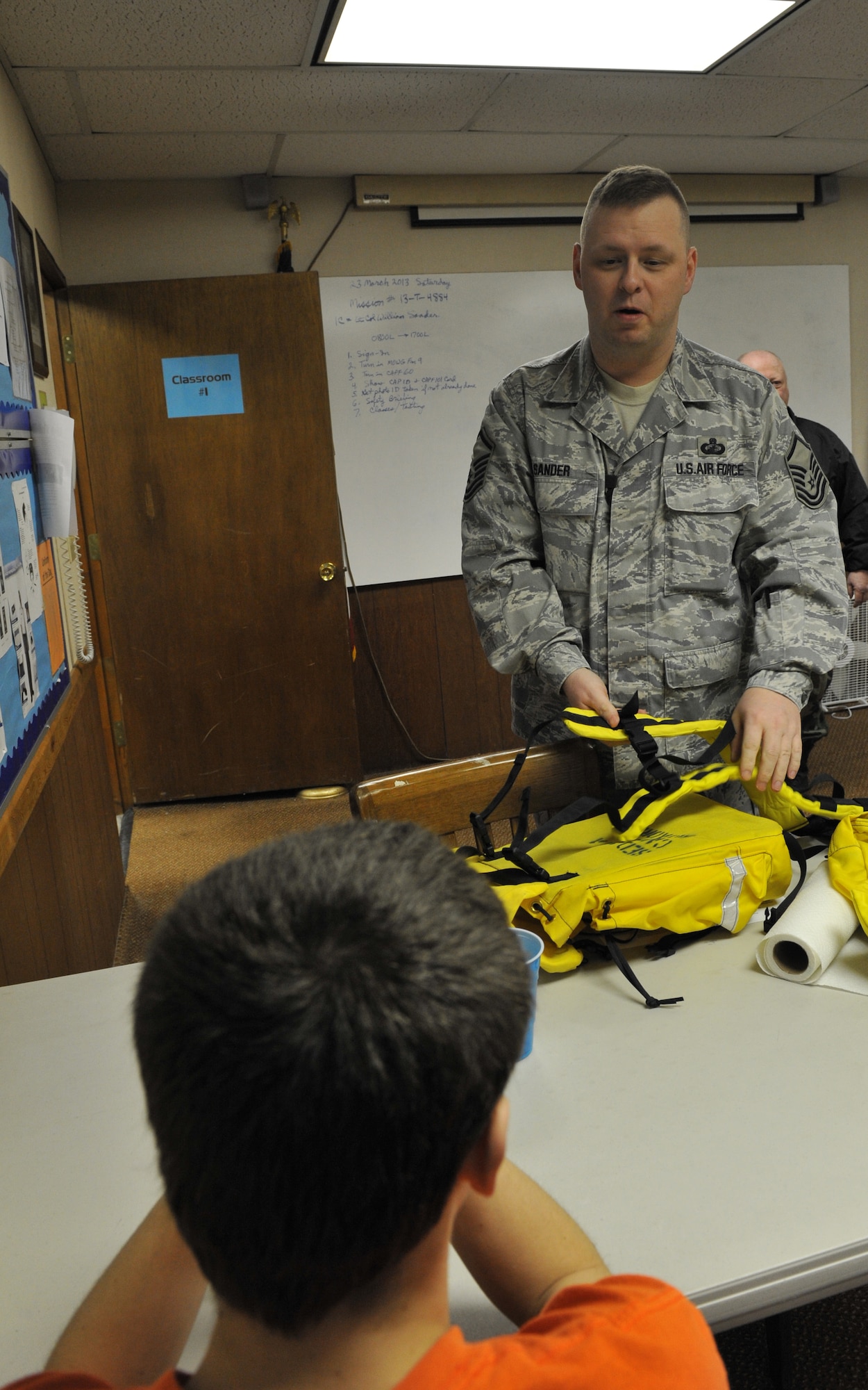 Master Sgt. William Sander, 509th Comptroller Squadron financial services superintendent, explains to a cadet how to assemble search and rescue field gear during a Civil Air Patrol meeting, March 28, 2013, in Sedalia, Mo. Cadets are taught how to use equipment for emergency services missions. (U.S. Air Force photo by Heidi Hunt/Released)