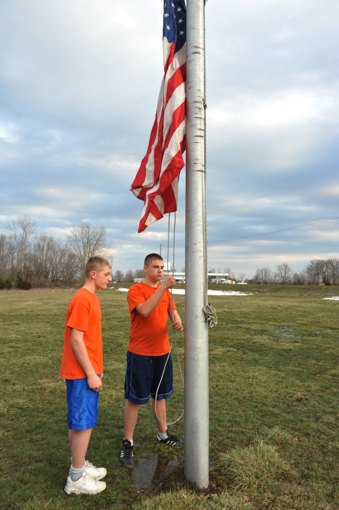 Camren, 15, and Jeremiah, 14, members of the Sedalia Civil Air Patrol squadron, raise the U.S. flag prior to their weekly meeting, March 28, 2013, in Sedalia, Mo. Interested individuals can learn more about opportunities available and membership eligibility during the squadron’s weekly Thursday meetings from 6:30-9 p.m. (U.S. Air Force photo by Heidi Hunt/Released)