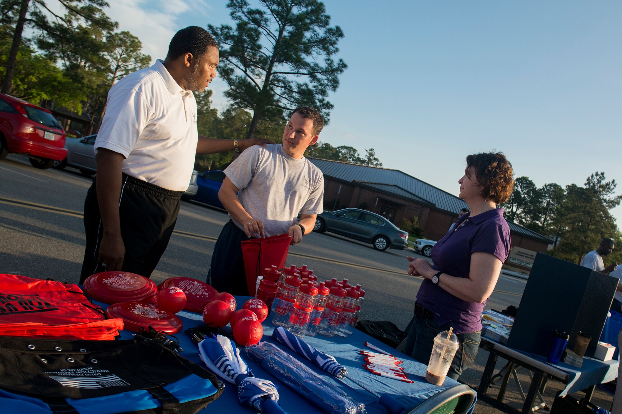 Retired U.S. Air Force Chief Master Sgt. Charles Boyd, 23d Medical Group Drug Demand Reduction Program (left), and Master Sgt. Angelita Pfeifer, 23d Medical Group, speak with Tech. Sgt. David Belles, 823d Base Defense Squadron, during an information fair April 19, 2013, at Moody Air Force Base, Ga. Various Integrated Delivery System agencies set up information booths in support of April’s awareness observances. (U.S. Air Force photo by Staff Sgt. Jamal D. Sutter/Released) 
