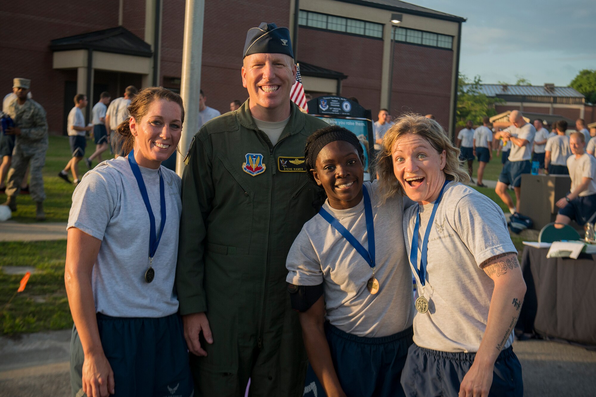 U.S. Air Force Col. Steven Ramer, 23d Wing vice commander, takes a photo with Airman 1st Class Kristen Kaltenbauch (left), Airman 1st Class Niya Law (center) and Tech. Sgt. Rachel Nelson during a 5K run April 19, 2013, at Moody Air Force Base, Ga. The three runners are all from the 823d Base Defense Squadron and were the first three women to complete the run. (U.S. Air Force photo by Staff Sgt. Jamal D. Sutter/Released)   
