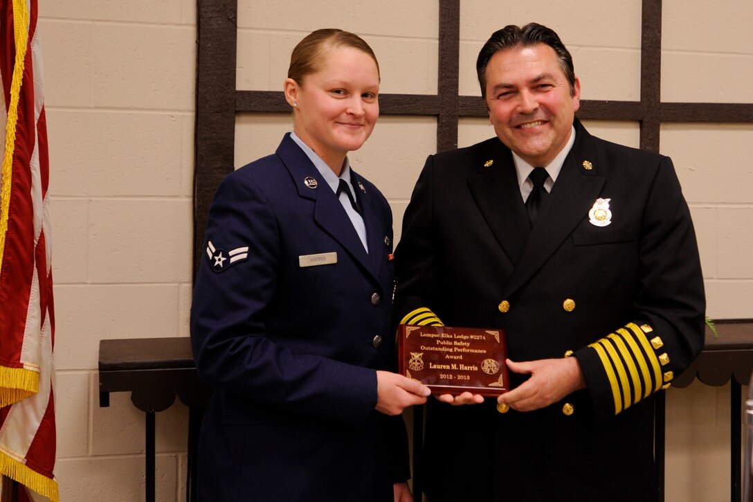 4/22/2013 – LOMPOC, Calif. – Airman 1st Class Lauren Harris, 30th Civil Engineer Squadron firefighter, and Mark Farias, 30th CES fire chief, pose for a photo during the Elks annual Public Employees Safety Night at the Lompoc Elks Lodge Thursday, April 18, 2013. The Lompoc Elks, a charitable foundation with a 141 year history, awarded Harris an Outstanding Performance Award for her passion for volunteering and professional accomplishments. (U.S. Air Force photo/Airman Yvonne Morales)