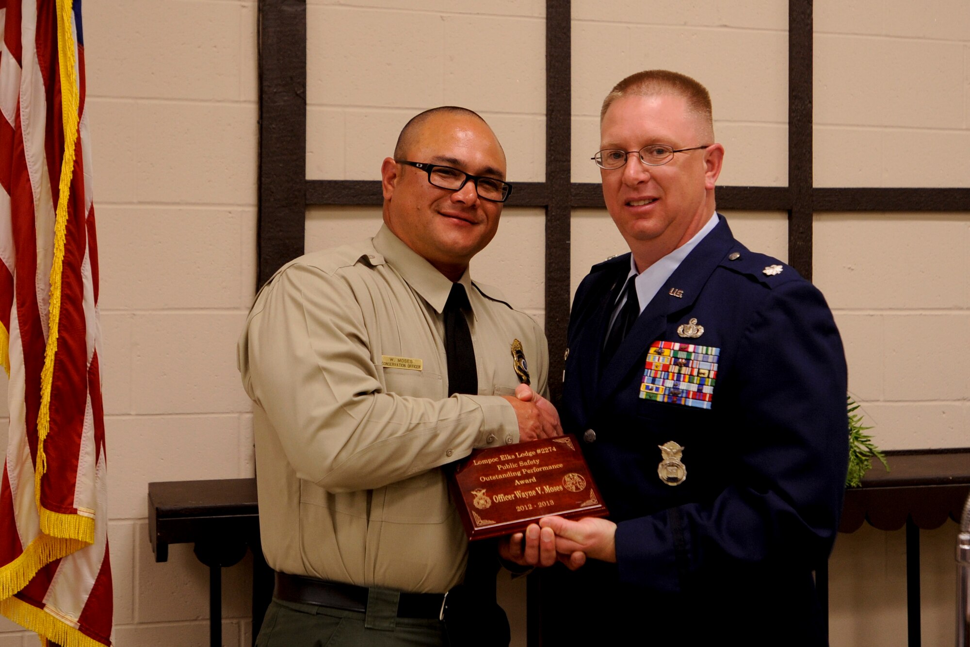 4/22/2013 – LOMPOC, Calif. – Officer Wayne V. Moses, 30th Security Forces Squadron officer, and Lt. Col. Gerald Mulhollen, 30th SFS commander, pose for a photo during the Elks annual Public Employees Safety Night at the Lompoc Elks Lodge Thursday, April 18, 2013. The Lompoc Elks, a charitable foundation with a 141 year history, awarded Moses an Outstanding Performance Award for his passion for volunteering and professional accomplishments. (U.S. Air Force photo/Airman Yvonne Morales)