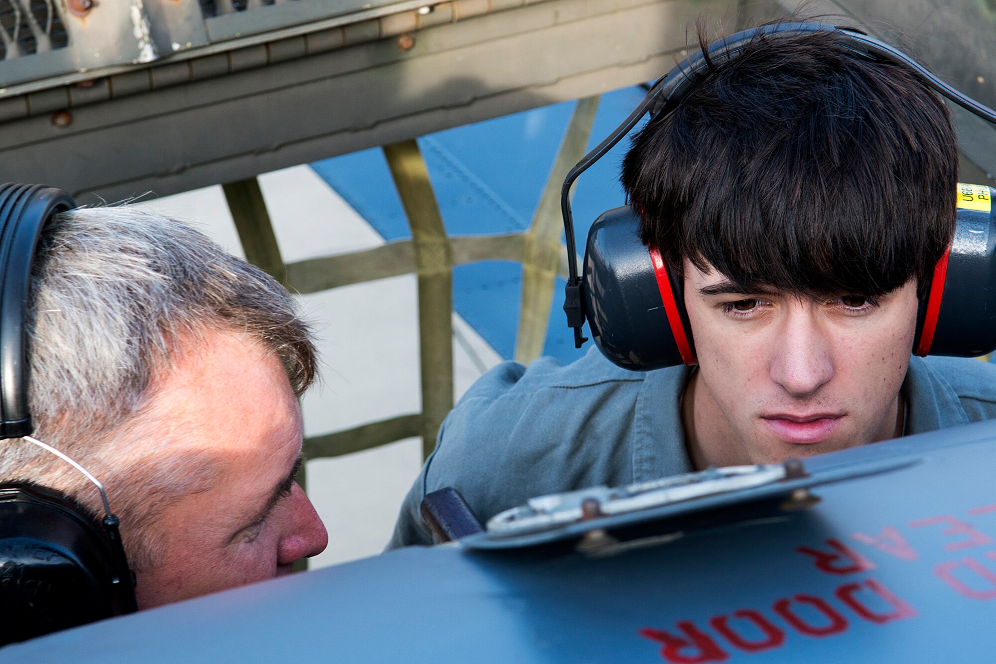 Daniel Phillips (right), a Haughton High School senior, is working on a military aviation project by studying the affect a drag parachute has on a B-52H Stratofortress, April 17, 2013, Barksdale Air Force Base, La. A drag chute is deployed from the tail section of a B-52H Stratofortress to help slow it down after landing. (U.S. Air Force photo by Master Sgt. Greg Steele/Released)