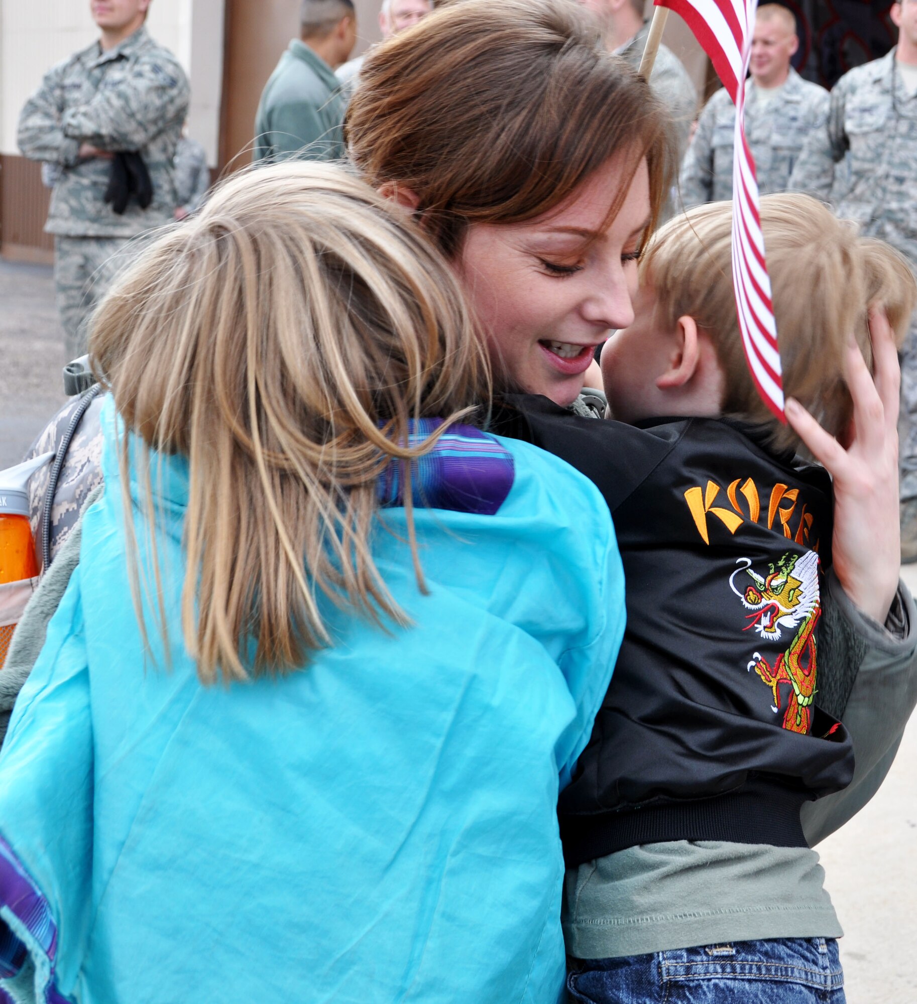 Staff Sgt. Alexandra Daniels, 419th Maintenance Squadron, shares a moment with her children, Aubree and Caige, after arriving home today from a four-month deployment to Kunsan Air Base in the Republic of Korea.