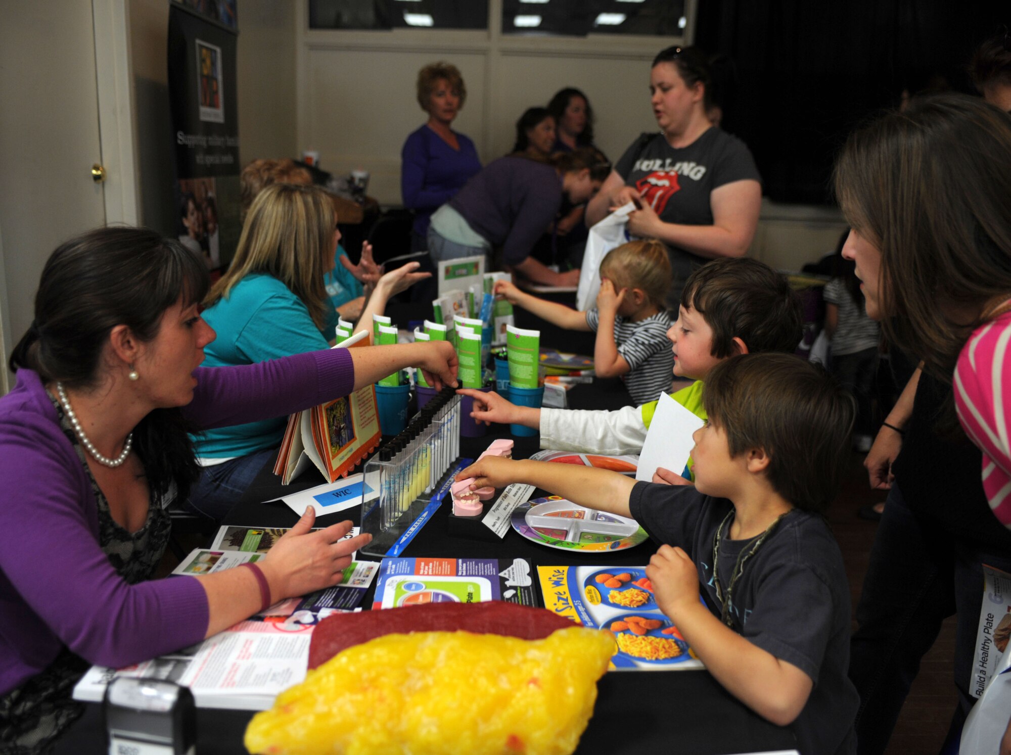 Families gather information about healthy eating at the inaugural Cannon Helping Hands celebration at Cannon Air Force Base, N.M., April 19, 2013. Helping Hands was held to bring awareness about base programs available for military families. (U.S. Air Force photo/Airman 1st Class Ericka Engblom)

