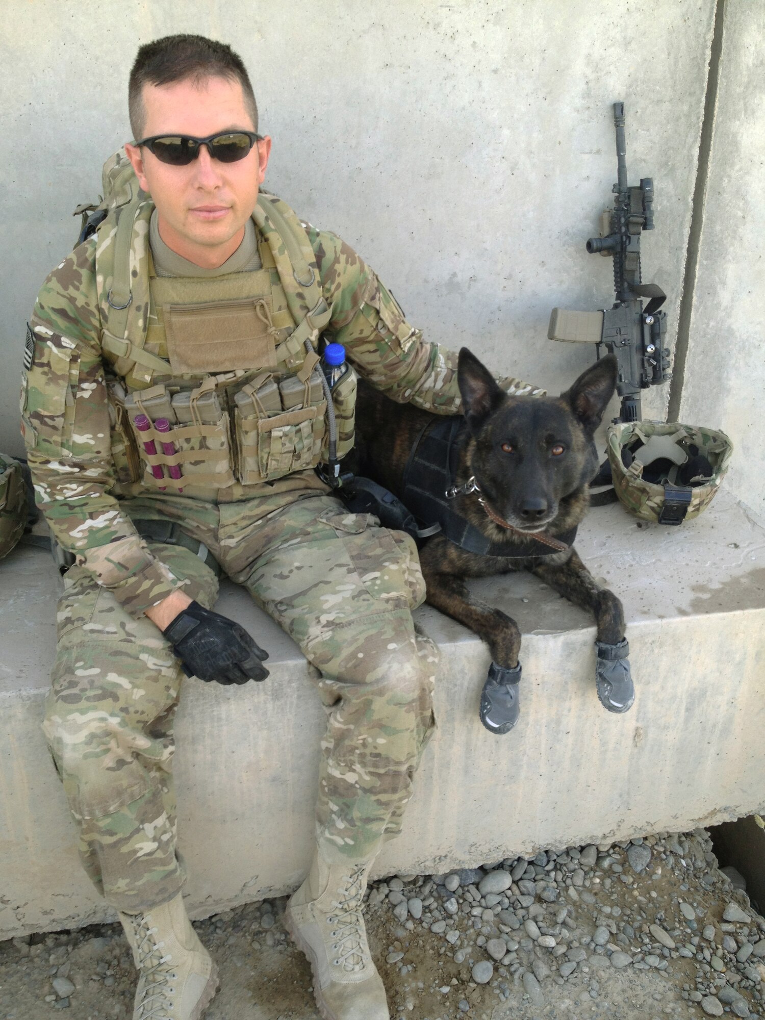 U.S. Air Force Staff Sgt. Robert Wilson, 366th SFS military working dog handler, and his dog Troll pause for a photo before heading out on a mission in the Kandahar Province during June 2012. The team led the Joint Task Force and Afghan National Army Soldiers through more than two miles of improvised explosive device infested poppy fields and extremely rough terrain in order to safely reach their final objective. (Courtesy photo) 