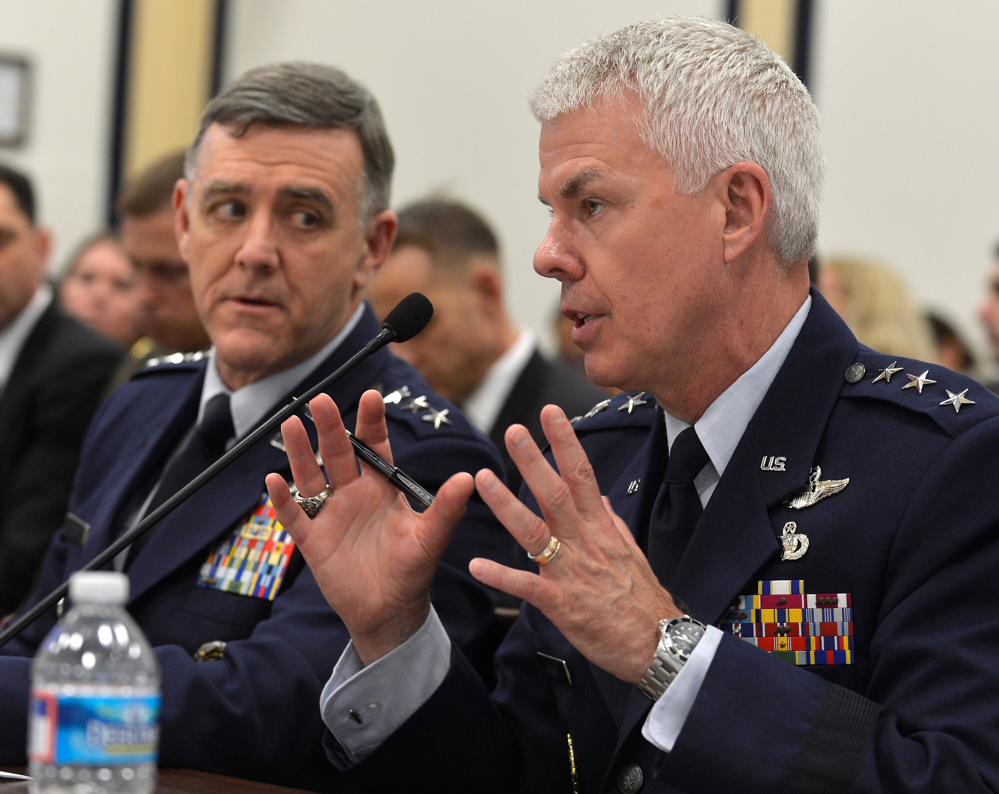 Air Force Lt. Gen. Burton Field looks on while U.S. Air Force Lt. Gen. Charles Davis answers a question posed to him about combat aviation programs being budgeted for fiscal year 2014 during a hearing of the House Armed Services Committee's Tactical Air and Land Forces Subcommittee on Capitol Hill, Washington, D.C., April 17, 2013. Davis is the Military Deputy, Office of the Assistant Secretary of the Air Force for Acquisition. He is responsible for research and development, test, production and modernization of Air Force programs. Field is deputy chief of staff for operations, plans and requirements and also serves as the Air Force operations deputy to the Joint Chiefs of Staff. . (U.S. Air Force photo/Jim Varhegyi)