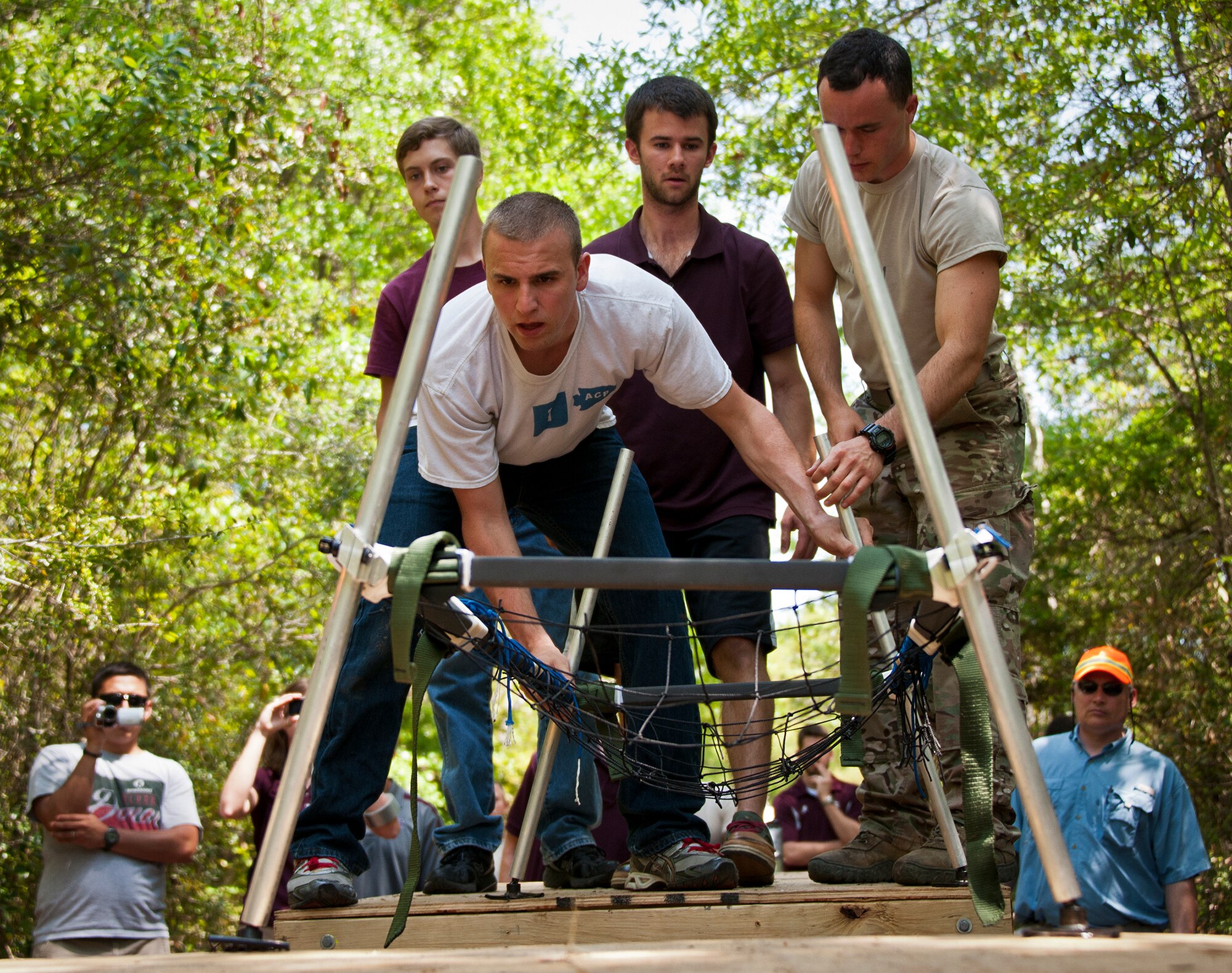 Texas A&M students try to steady their bridge across two platforms to prove its capabilities during the Air Force Research Lab’s Design Competition held April 15-20 at the Air Force Enlisted Village in Shalimar, Fla.  Teams were given the warfighter-focused engineering design challenge, Portable Bridge Technology, $20,000, and nine months to create a demonstrable solution.  All three service academies and 17 universities competed in the challenge this year.  (U.S. Air Force photo/Samuel King Jr.)