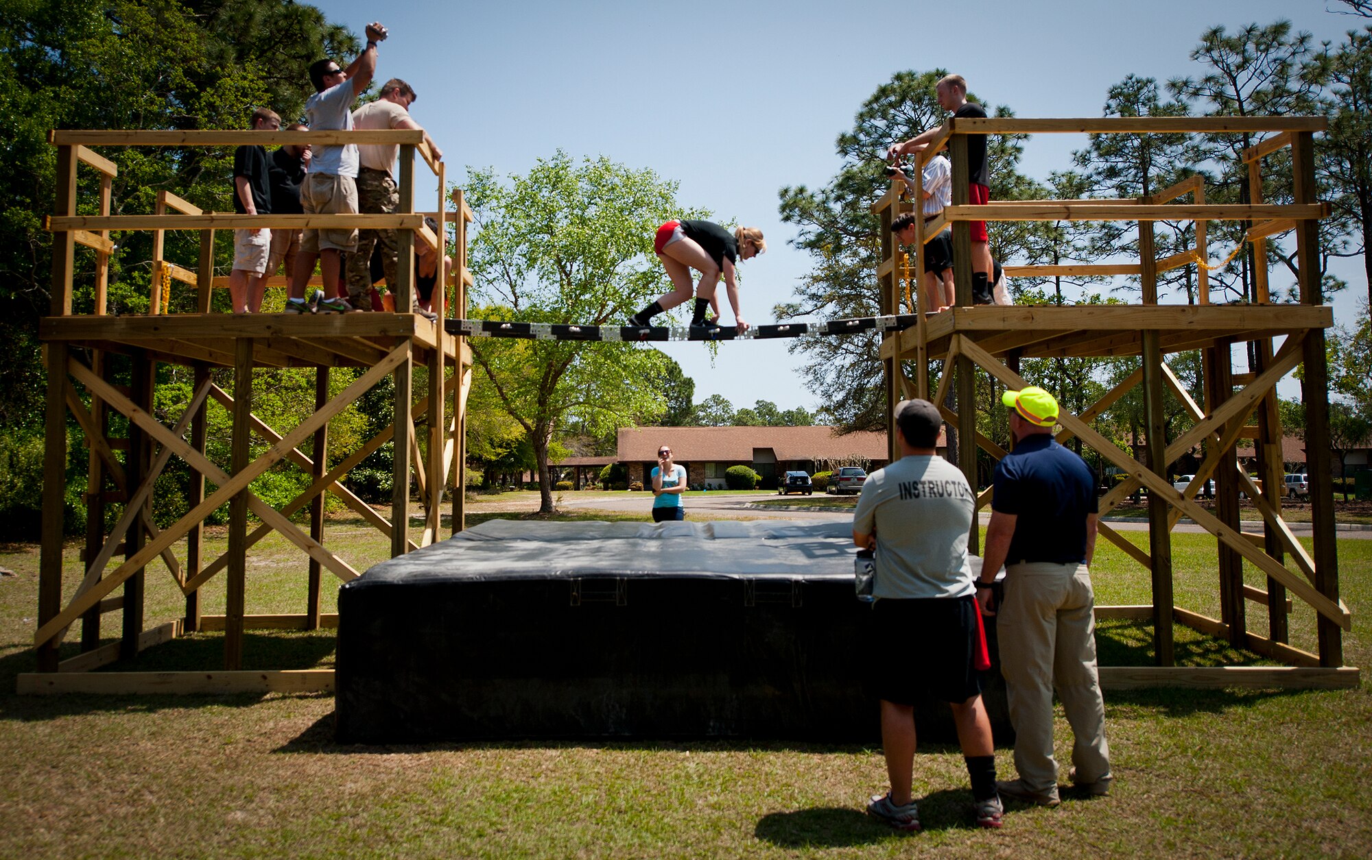 An Ohio State University student walks across their constructed bridge to prove its capabilities during the Air Force Research Lab’s Design Competition held April 15-20 at the Air Force Enlisted Village in Shalimar, Fla.  Teams were given the warfighter-focused engineering design challenge, Portable Bridge Technology, $20,000, and nine months to create a demonstrable solution.  All three service academies and 17 universities competed in the challenge this year.  (U.S. Air Force photo/Samuel King Jr.)