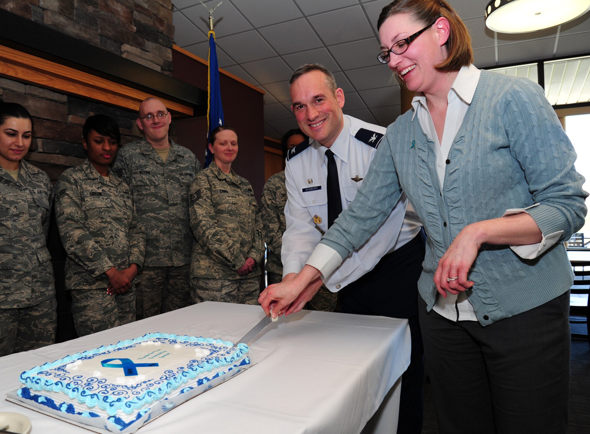 Col. Brian Newberry, 92nd Air Refueling Wing commander, and Jessica Bradshaw, Sexual Assault Response coordinator, cut a cake in celebration of Sexual Awareness Month at Fairchild Air Force Base, Wash., April 17, 2013. During this ceremony, victim advocates were recognized for their hard work and dedication to the SARC program. (U.S. Air Force photo by Airman 1st Class Janelle Patiño)