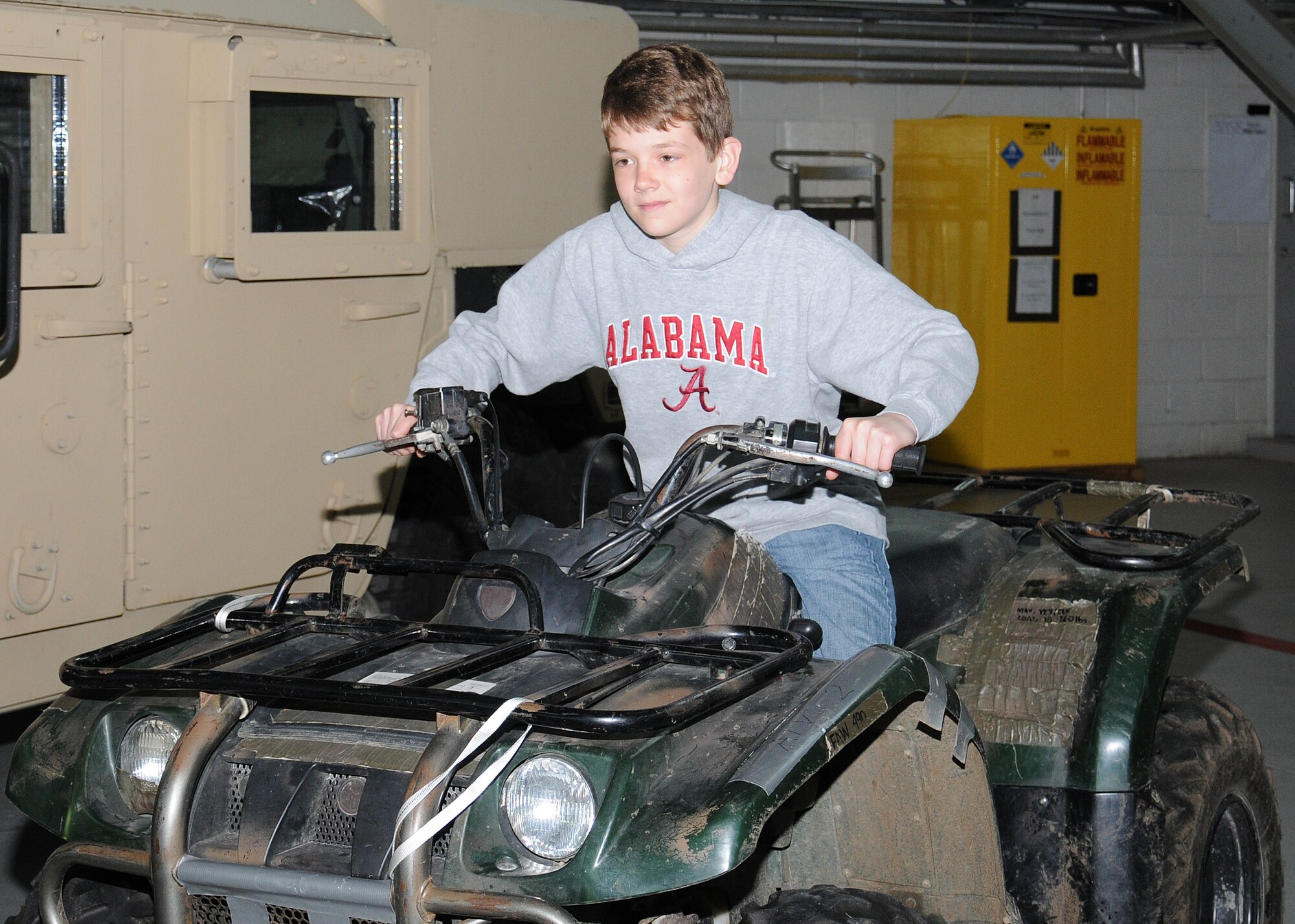 Shaun Freeman, 13, son of Lt. Col. William Freeman, 7th Special Operations Squadron commander, sits on a Yamaha Kodiak 400 all terrain vehicle April 19, 2013, at RAF Mildenhall, England. As part of Job Shadow Day, children learned about various U.S. Air Force career fields including the 100th Civil Engineer Squadron, the 100th Communications Squadron and the 100th Force Support Squadron. (U.S. Air Force photo by Gina Randall/Released)