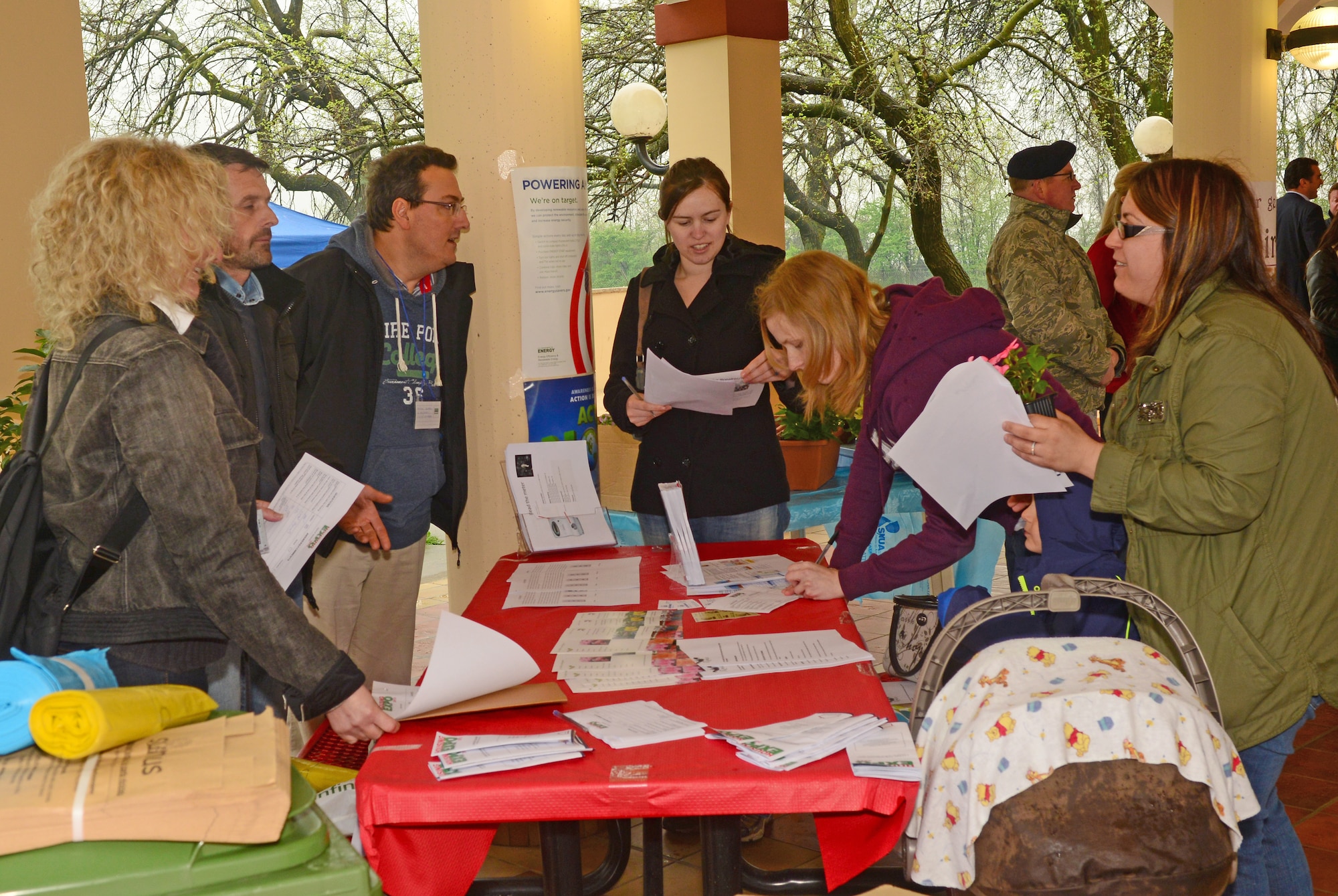 Employees from the 31st Civil Engineer Squadron housing office talk  to attendees about the importance of energy conservation during the housing expo April 22, 2013 at Aviano Air Base, Italy. The expo offered attendees practical and useful information on a variety of housing issues to include maintenance and repair, “how to” demonstrations, government furnishings, legal assistance, landlords and property management, gardening and recycling. (U.S. Air Force photo/Airman 1st Class Briana Jones)


