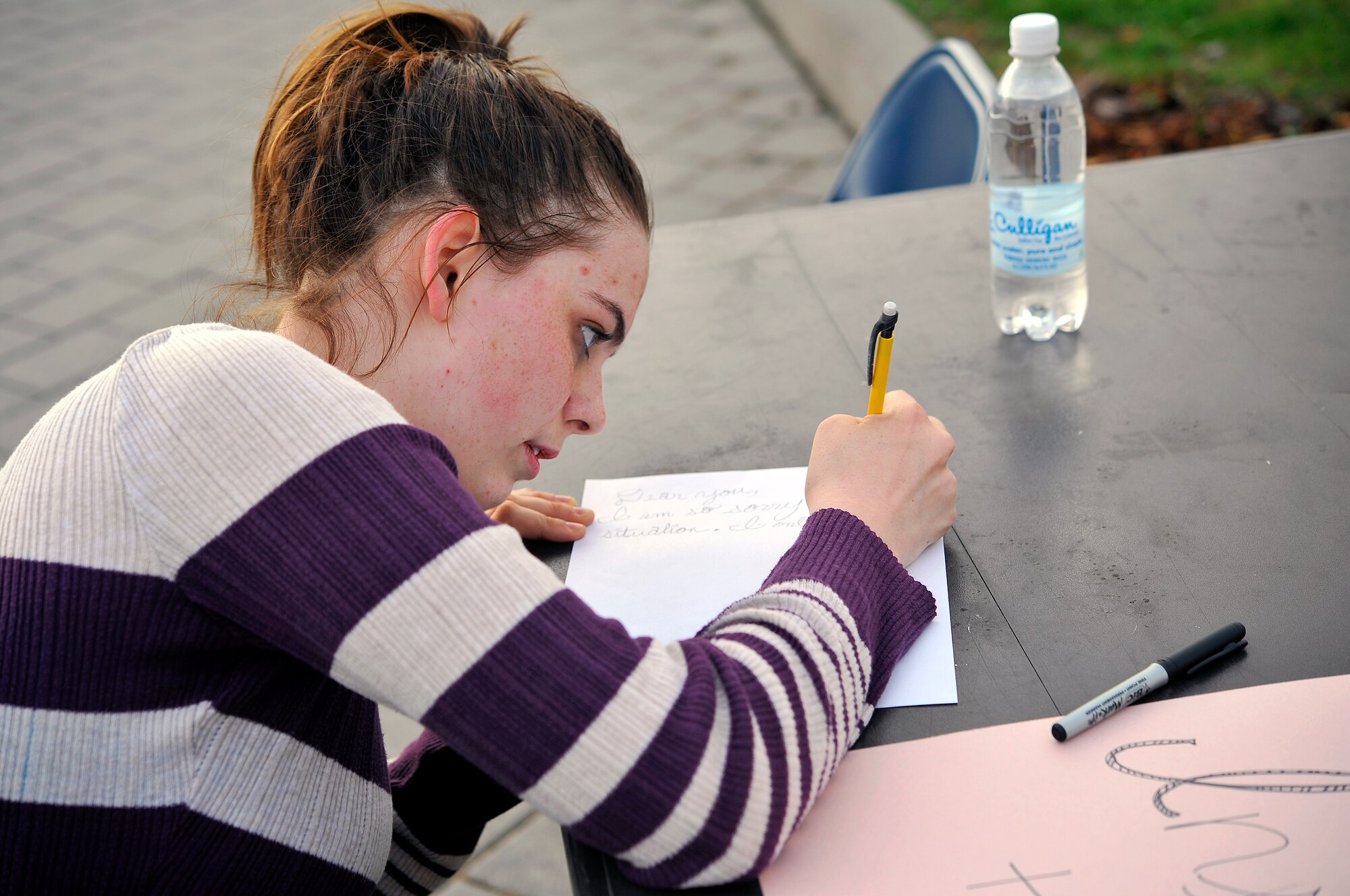 Kayla Kessel, Ramsetein High School senior, writes a letter of encouragement for members of a Covenant House in the U.S. during the Solidarity Sleep Out event April 19, 2013, Ramstein Air Base, Germany. The sleep out was organized by the Ramstein Keystone Club and was aimed at raising awareness for the homeless. (U.S. Air Force photo/Airman 1st Class Trevor Rhynes)
