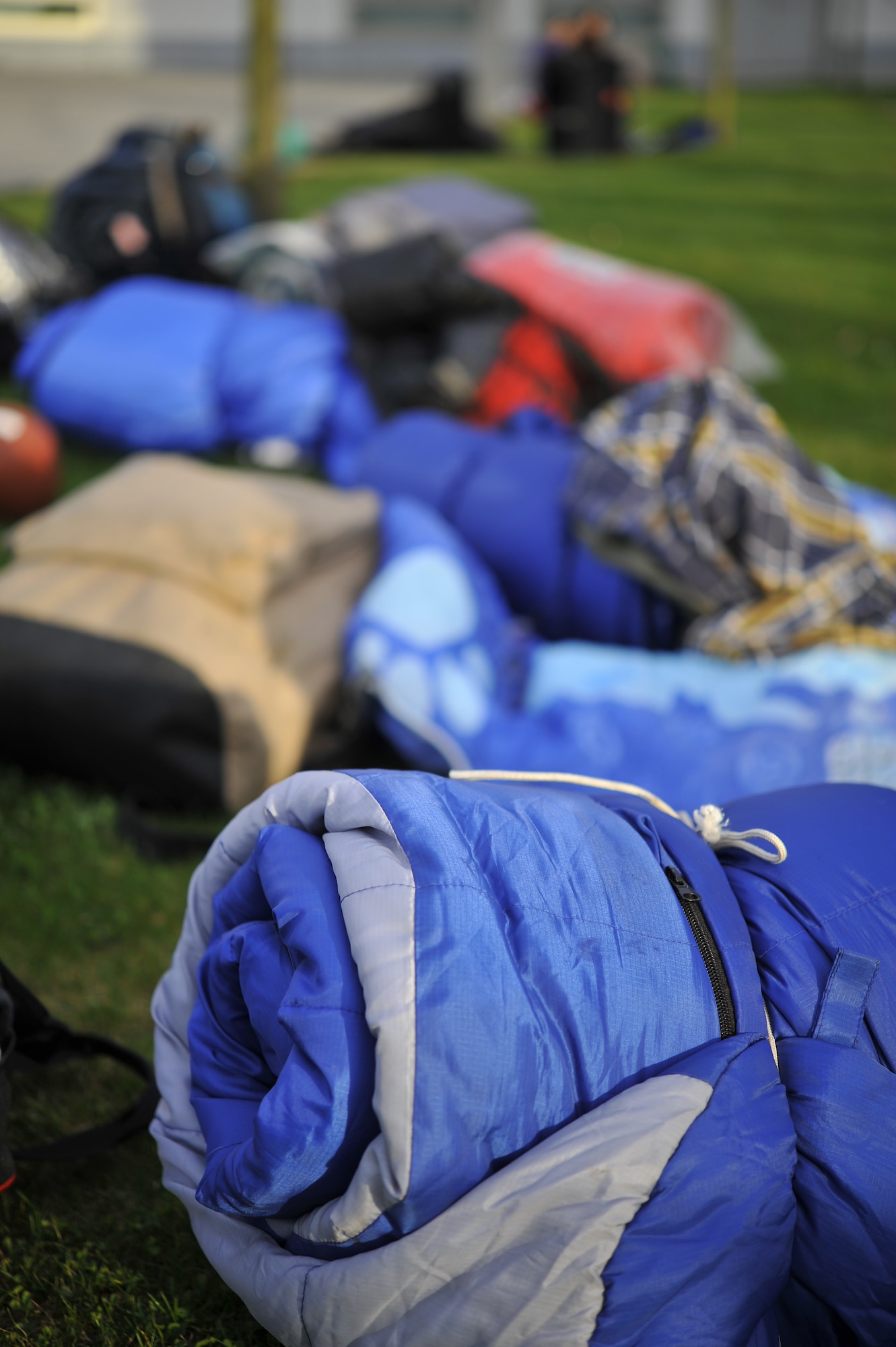 Sleeping bags and backpacks lay on the ground at the Solidarity Sleep Out event, April 19, 2013, Ramstein Air Base, Germany. The sleep out was organized by the Ramstein Keystone Club and was aimed at raising awareness for the homeless. (U.S. Air Force photo/Airman 1st Class Trevor Rhynes)

