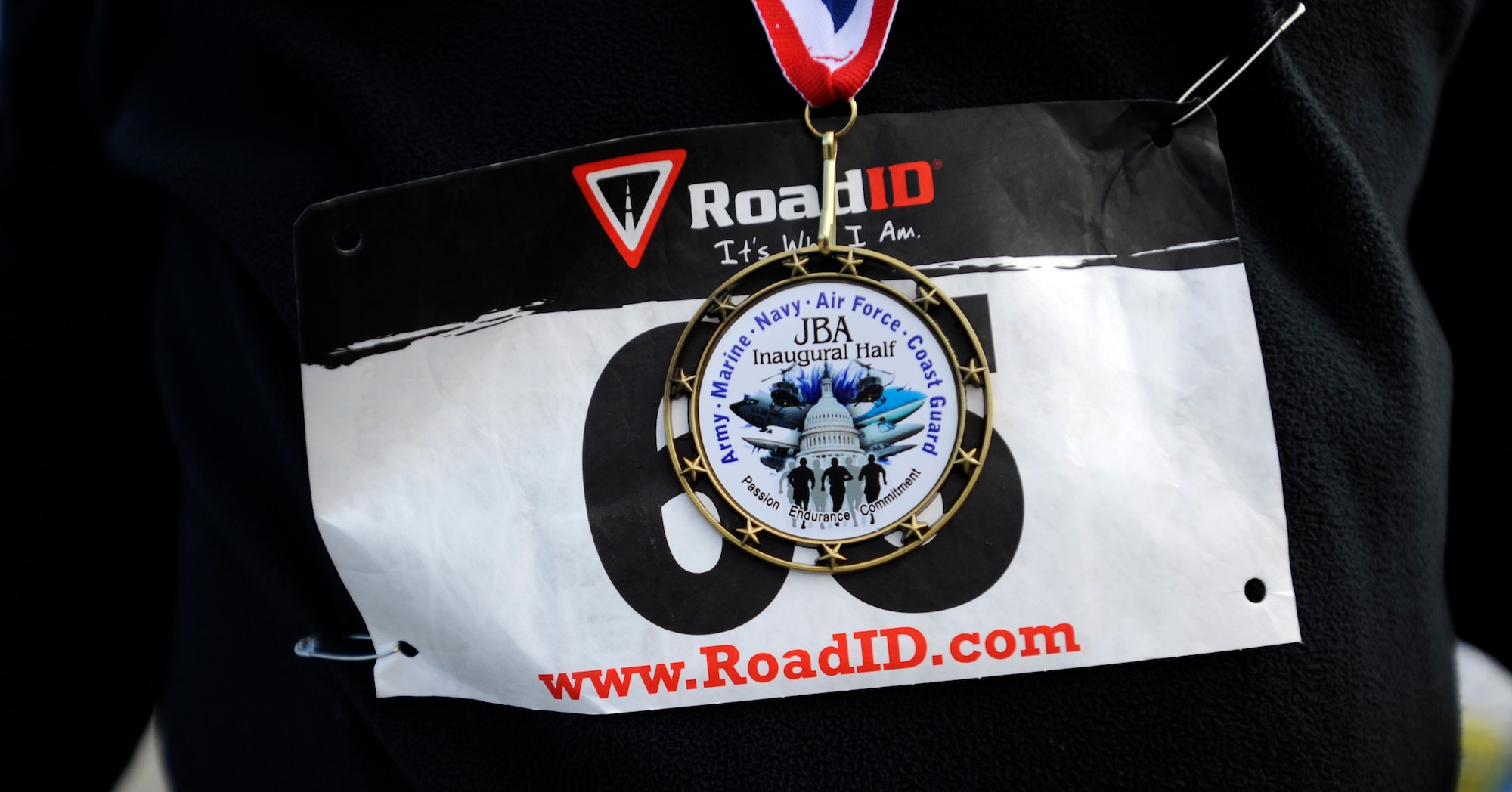 Participants of the Inaugural Joint Base Andrews Half Marathon are awarded with medals as they cross the finish line April 20, 2013. The first place runner was Brenda Shrank who finished with a time of one hour, 24 minutes and nine seconds. (U.S. Air Force photo/Staff Sgt. Brittany E. Jones)
