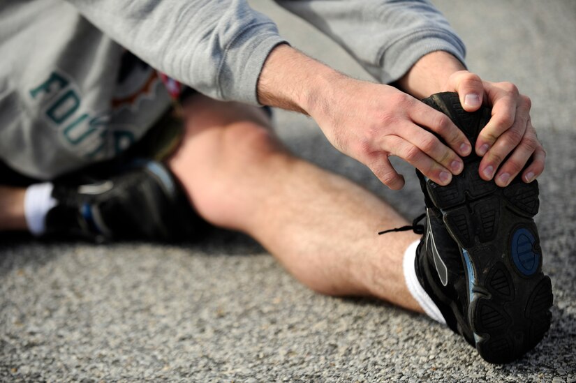 A runner stretches after completing a half marathon April 13, 2013 at Joint Base Andrews, Md. The first place runner was Brenda Shrank who crossed the finish line at one hour, 24 minutes and nine seconds. (U.S. Air Force photo/Staff Sgt. Brittany E. Jones)