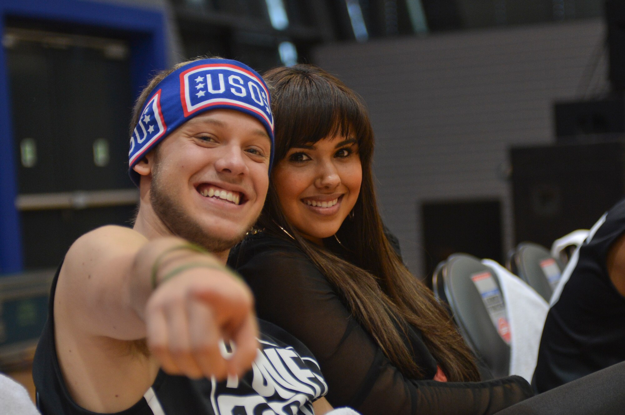 A member of 4 Count & PWD and Kristinia DeBarge sit on the sidelines during the Power 106 and Nick Cannon N 'Credible United Service Organization tour on Ramstein Air Base, Germany, April 19, 2013. USO's lineup included actors, musicians and comedians competing against Ramstein's finest basketball players in a morale event to show support to the troops. (U.S. Air Force photo/Airman 1st Class Jordan Castelan)