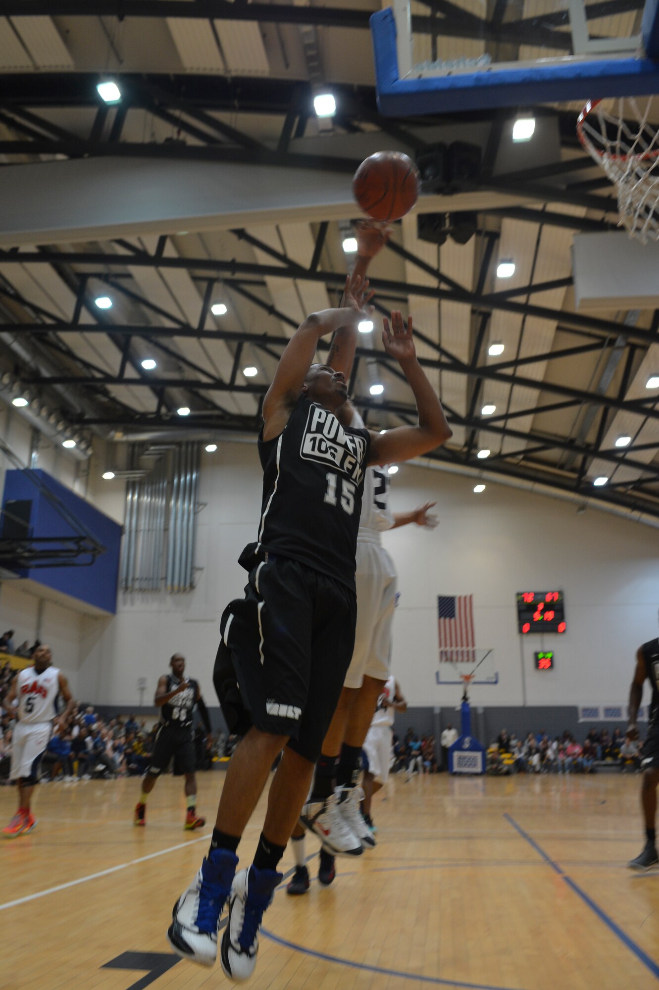Staff Sgt. Bill Pryor, 721st Air Mobility Command, blocks Nick Cannon during the Power 106 and Nick Cannon N 'Credible United Service Organization tour, a friendly exhibition match against Ramstein's varsity basketball team on Ramstein Air Base, Germany, April 19, 2013. USO's lineup included actors, musicians and comedians competing against Ramstein's finest basketball players in a morale event to show support to the troops. (U.S. Air Force photo/Airman 1st Class Jordan Castelan)