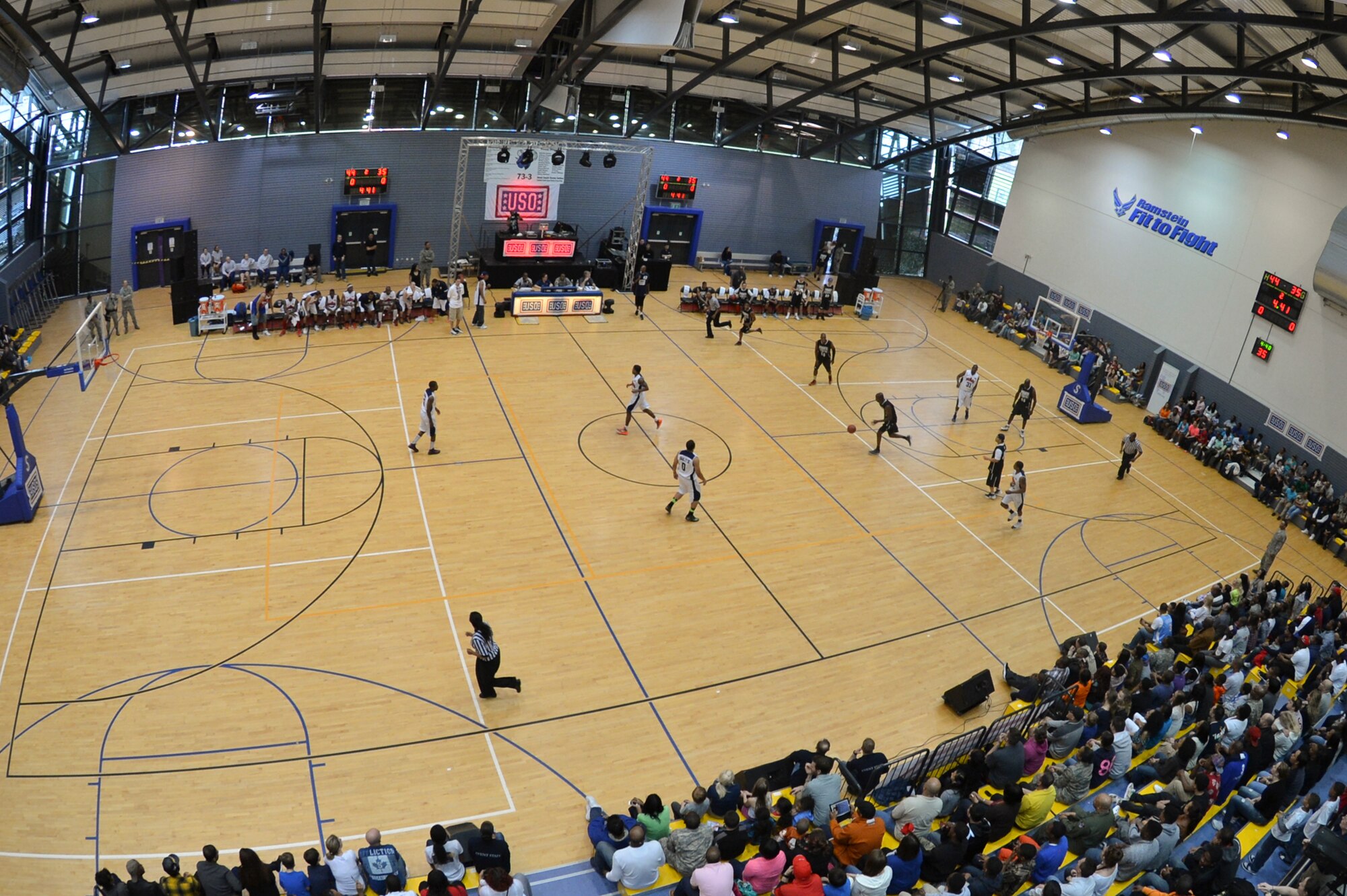 Members of the Power 106 and Nick Cannon N 'Credible United Service Organization tour participated in a friendly exhibition match against Ramstein's varsity basketball team on Ramstein Air Base, Germany, April 19, 2013. USO's lineup included actors, musicians and comedians competing against Ramstein's finest basketball players in a morale event to show support to the troops. (U.S. Air Force photo/Airman 1st Class Jordan Castelan)