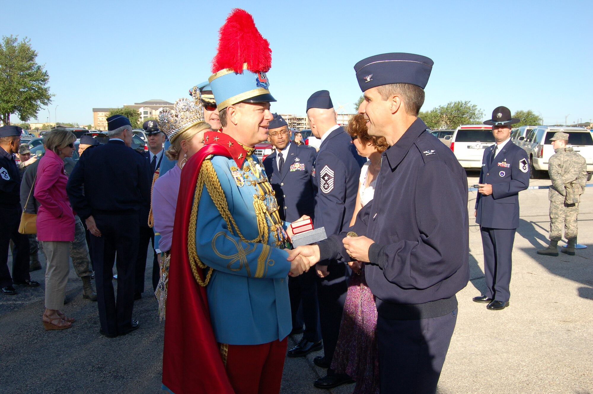 Col. Jeffrey T. Pennington, 433rd Airlift Wing commander, right, greets King Antonio XCI, Steve Dutton, as he arrives at the Joint Base San Antonio-Lackland Fiesta Military Parade held April 19.The parade is one of limited military events held during Fiesta, a ten-day celebration that honors the memory of the Texan troops who died defending the Alamo during the 1836 Texas Revolution. (U.S. Air Force Photo/Elsa Martinez)  