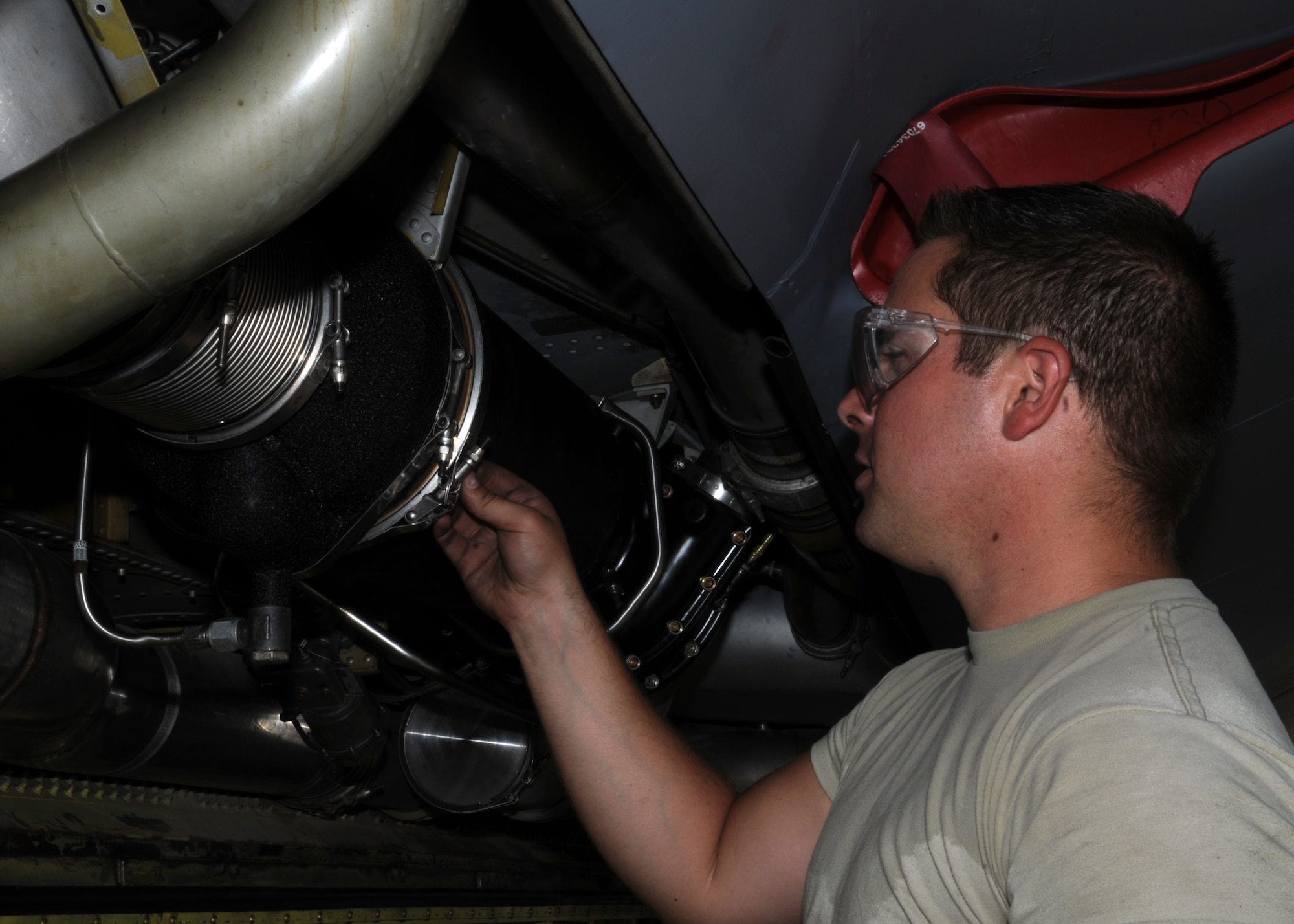 Senior Airman William Studley, 100th Maintenance Squadron, finishes installing the air cycle machine (ACM) on a KC-135 Stratotanker while deployed with the 351st Expeditionary Air Refueling Squadron April 18, 2013, in Southwest Europe. The ACM feeds air into the fuselage and cockpit of the aircraft to help regulate the internal temperature and climate during flight, which helps keep the aircraft fully functional. (U.S. Air Force photo by 1st Lt. Christopher Mesnard/Released)