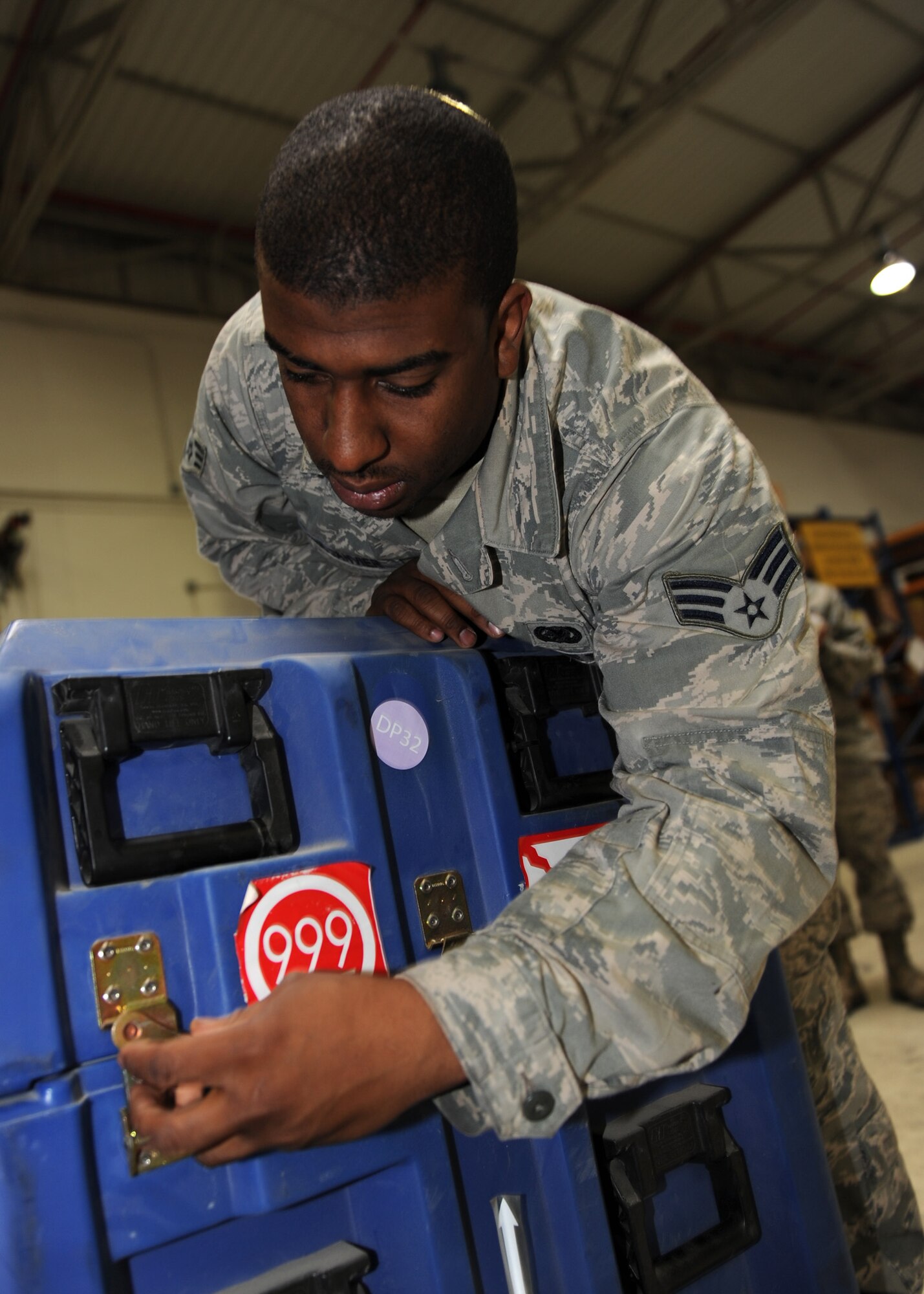 Senior Airman Jason Palmer-Janvier, 39th Logistics Readiness Squadron material management technician, locks down a container of aircraft parts April 18, 2013 at the Incirlik Air Base Material Management Warehouse. One responsibility of the Material Management Flight is to schedule the shipment of items requested by another installation or in need of repair. (U.S. Air Force photo by Senior Airman Chase Hedrick)