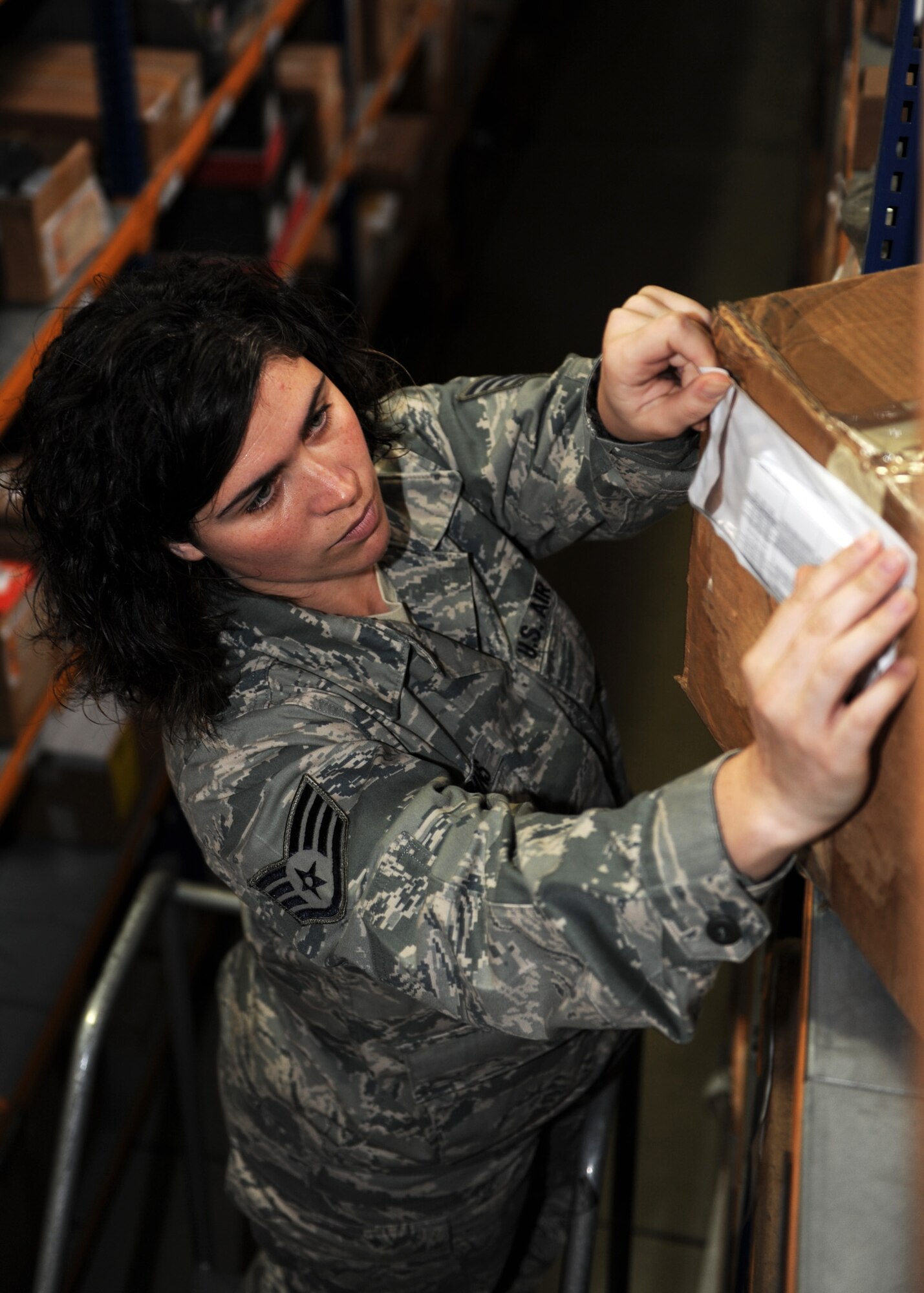 Staff Sgt. Jessica Robbins, 39th Logistics Readiness Squadron supplies inspector, attaches warranty information to a box in the Incirlik Air Base Material Management Warehouse April 18, 2013. The inspections section of the Material Management Flight ensures the inventory is properly maintained and organized. (U.S. Air Force photo bySenior Airman Chase Hedrick/Released)