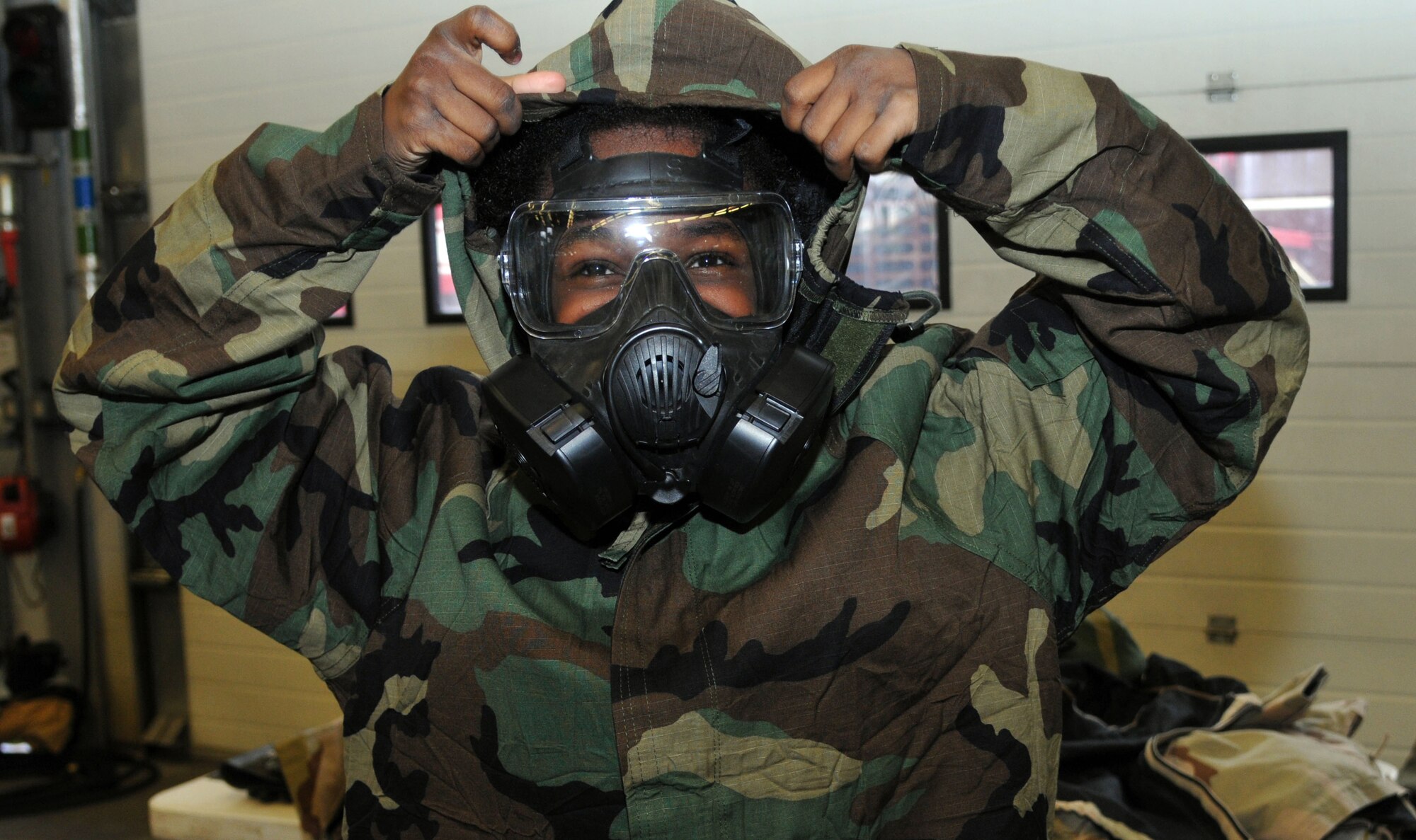 Caira Green, 11, daughter of Joe Dale, 100th Communications Squadron telecommunications specialist from Vacaville, Calif., dons Mission Oriented Protective Posture gear at Job Shadow Day April 19, 2013, at the fire department on RAF Mildenhall, England. Job Shadow Day allowed children from the Department of Defense Schools on RAF Lakenheath and RAF Feltwell, England, a chance to experience different U.S. Air Force career fields. (U.S. Air Force photo by Airman 1st Class Kelsey Waters/Released)