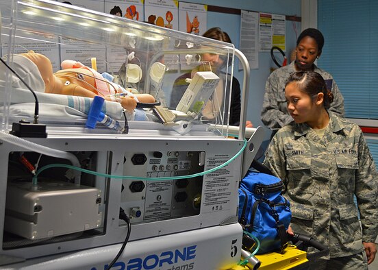 Staff Sgt. Christina Marie Smith, 31st Aerospace Medicine Squadron ambulance service technician, monitors the vital signs of a simulated infant being transported to the Pordenone Hospital from Aviano Air Base, Italy, March 14.  Base and Pordenone medical personnel teamed up for the region's first international exercise to strengthen their working relationship and provide better care to patients. (Courtesy photo)