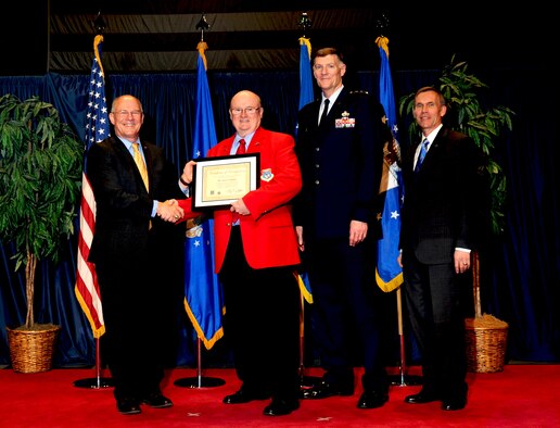 DAYTON, Ohio -- Garry Guthrie (red jacket) received the 2012 Director’s Award for Volunteer of the Year for his dedication and excellence in serving the National Museum of the U.S. Air Force. (U.S. Air Force photo by Jeff Fisher) 