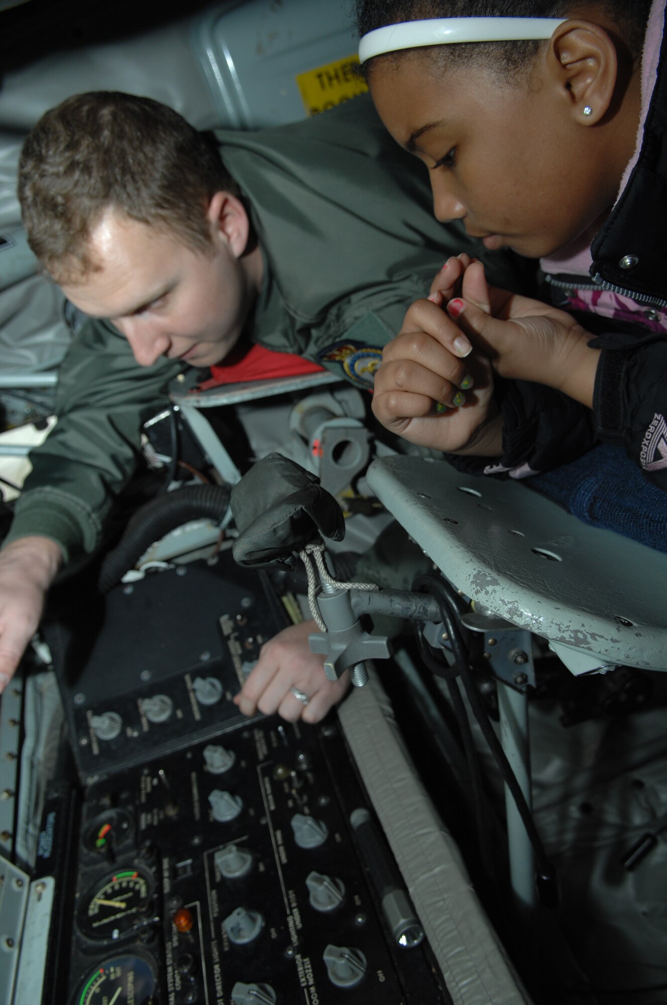 Kyana Bispat, daughter of Tech. Sgt. Edwin Bispat, 100th Communications Squadron unit training manager from Bridgeport, Conn., learns how to operate the boom on a KC-135 Stratotanker April 19, 2013, on RAF Mildenhall, England. Job Shadow Day participants viewed static displays of equipment used by various shops around base. The KC-135 Stratotanker, fire trucks and fuel trucks were just a few of the displays participants got to explore. (U.S. Air Force photo by Airman 1st Class Dillon Johnston/Released)