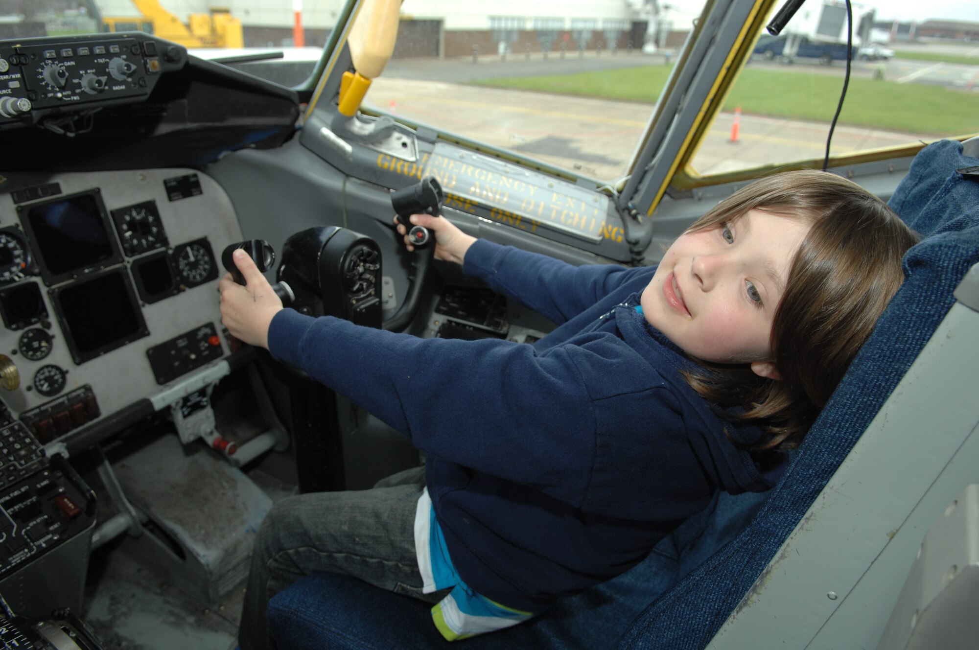 Gabriel Blankenship, 7, son of Master Sgt. Dana Blankenship, 48th Civil Engineer Squadron Pavements and Equipment NCO in charge from RAF Lakenheath, England, uses the controls on a static KC-135 Stratotanker aircraft during Job Shadow Day April 19, 2013, on RAF Mildenhall, England. Job Shadow Day is an academically-motivating activity designed to give students the unique opportunity to take an up-close look at various Air Force careers such as firefighters, security forces patrolmen and air traffic controllers. (U.S. Air Force photo by Airman 1st Class Dillon Johnston/Released)
