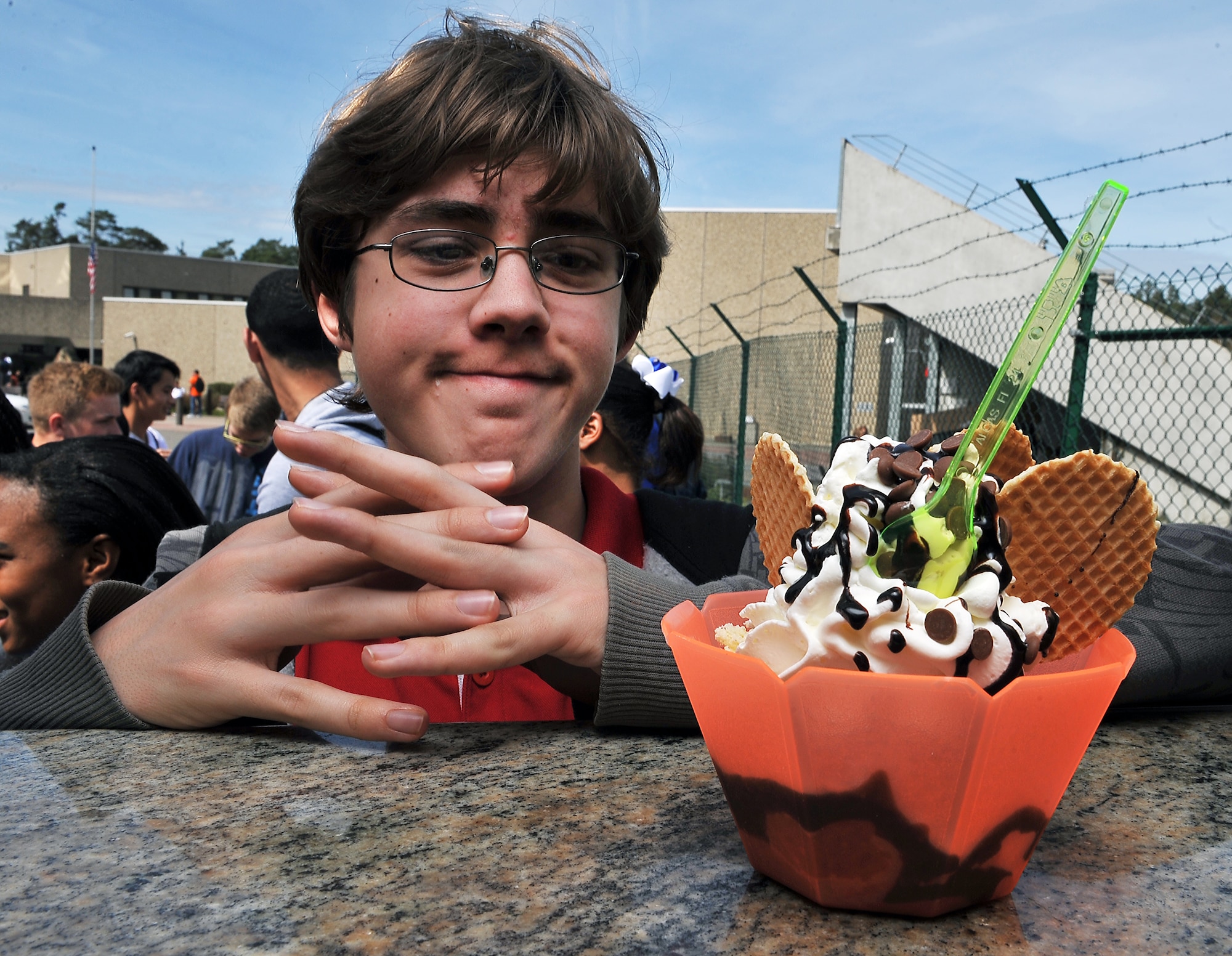 A student from Ramstein High School waits to pay for his frozen treat, April 19, 2013, Ramstein Air Base, Germany. Fabio Montebello, known by base locals as “Fabio the gelato man,” is an ice cream vendor who travels more than an hour away every day to deliver frozen treats to the base. (U.S. Air Force photo/Airman 1st Class Dymekre Allen)     