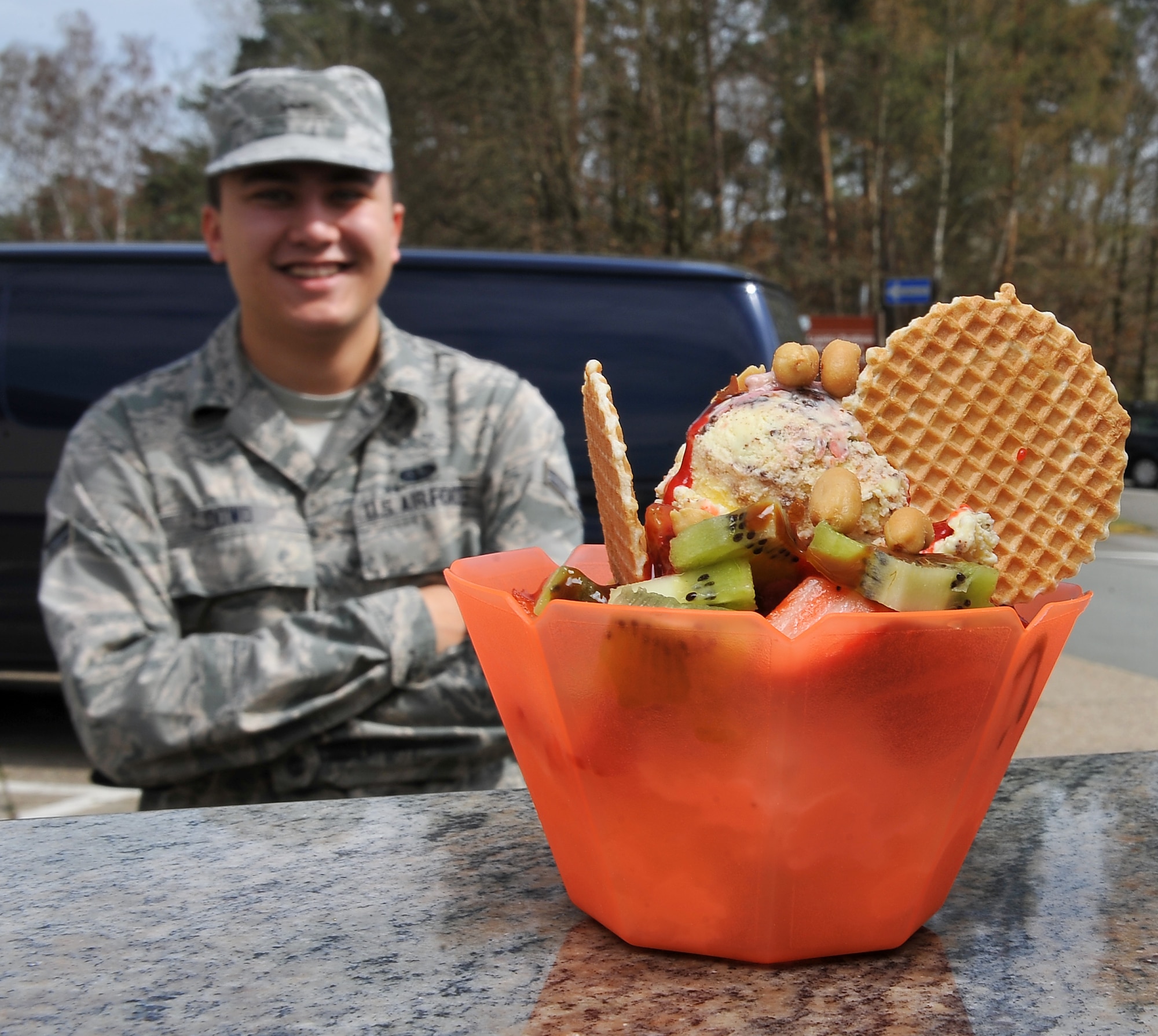 Airman 1st Class Erick Dowd, 4th component maintainer squadron Avionics technician waits on the completion of his frozen treat, April 19, 2013, Ramstein Air Base, Germany. Fabio Montebello, known by base locals as “Fabio the gelato man,” is an ice cream vendor who travels more than an hour away every day to deliver frozen treats to the base. (U.S. Air Force photo/Airman 1st Class Dymekre Allen)     