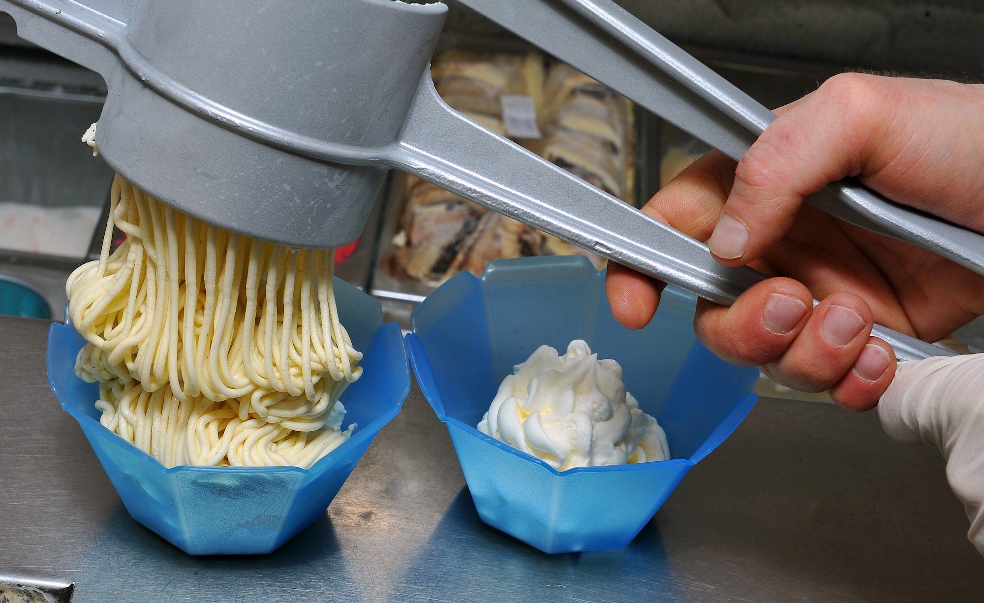 Fabio Montebello, base ice cream man, prepares “spaghetti ice” his most popular frozen treat, April 19, 2013, Ramstein Air Base, Germany. Fabio Montebello, known by base locals as “Fabio the gelato man,” is an ice cream vendor who travels more than an hour away every day to deliver frozen treats to the base. (U.S. Air Force photo/Airman 1st Class Dymekre Allen)     