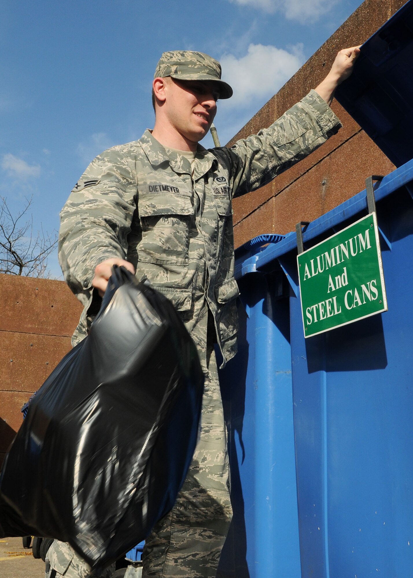 Airman 1st Class Jacob Dietmeyer, 100th Civil Engineer Squadron firefighter from Gurnee, Ill., recycles cans at a recycling collection point April 15, 2013, at RAF Mildenhall, England. The base recycling center also accepts recycling drop-offs Monday to Thursday from 8 a.m. to 4:15 p.m. and Friday from 8 a.m. to 3:15 p.m. (U.S. Air Force photo by Staff Sgt. Tabitha M. Lee/Released)