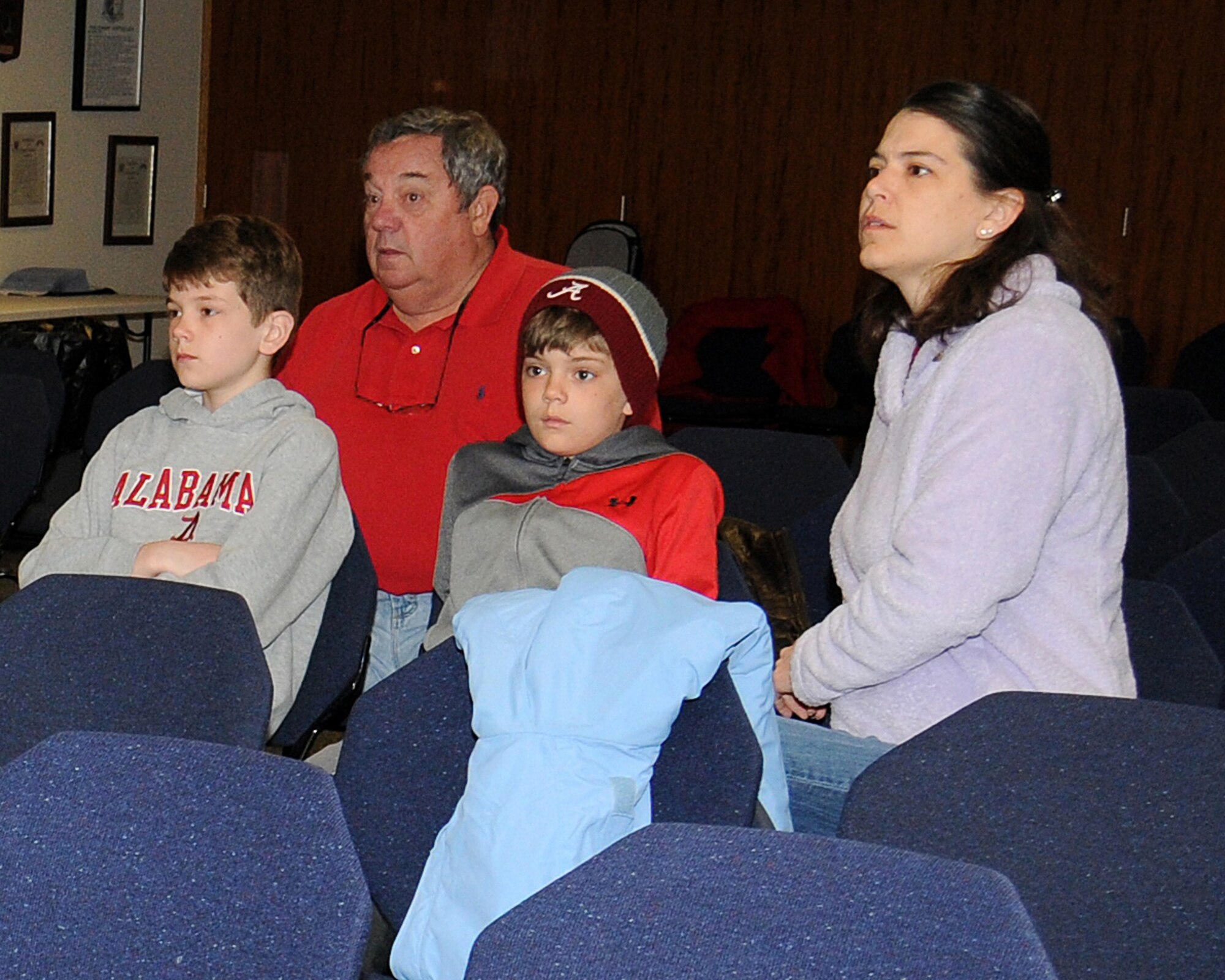 The Freeman family watches an informative video from the 7th Special Operations Squadron April 19, 2013, at RAF Mildenhall, England. The video was part of Job Shadow Day where Service members and their children learned about the U.S. Air Force career fields. (U.S. Air Force photo by Gina Randall/Released) 